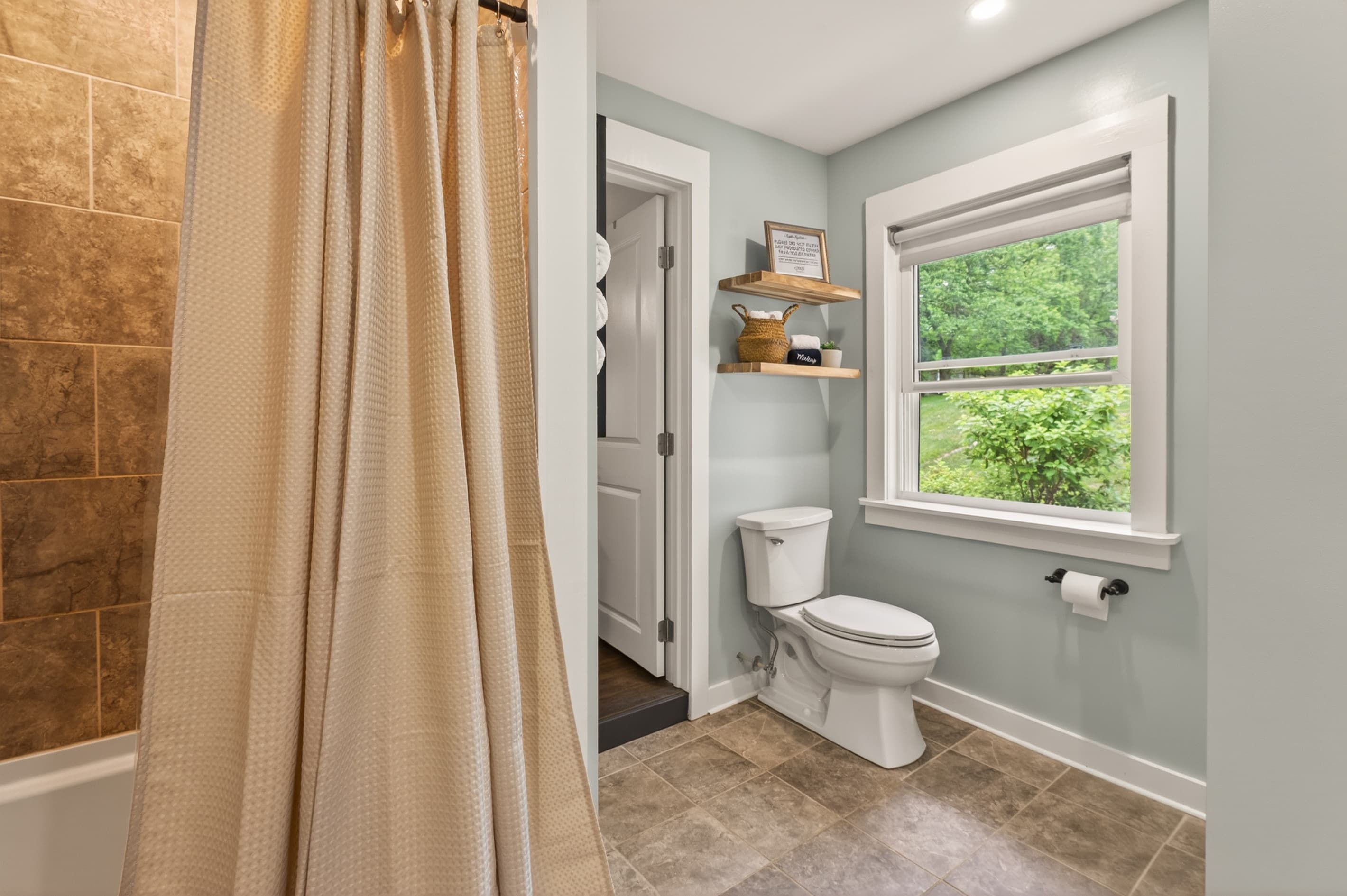 Bathroom with toilet and window