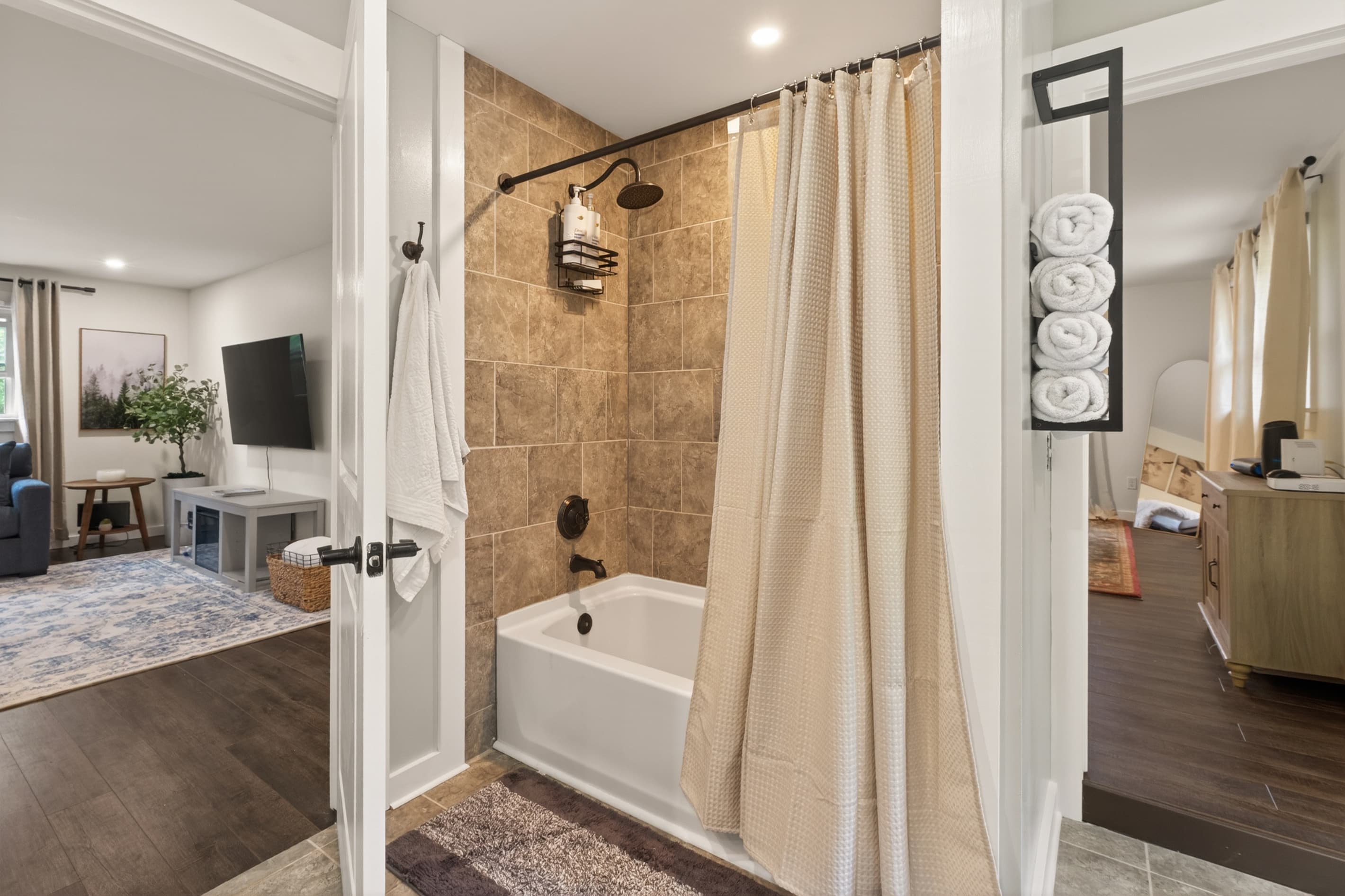 Bathtub with shower curtain beside living area