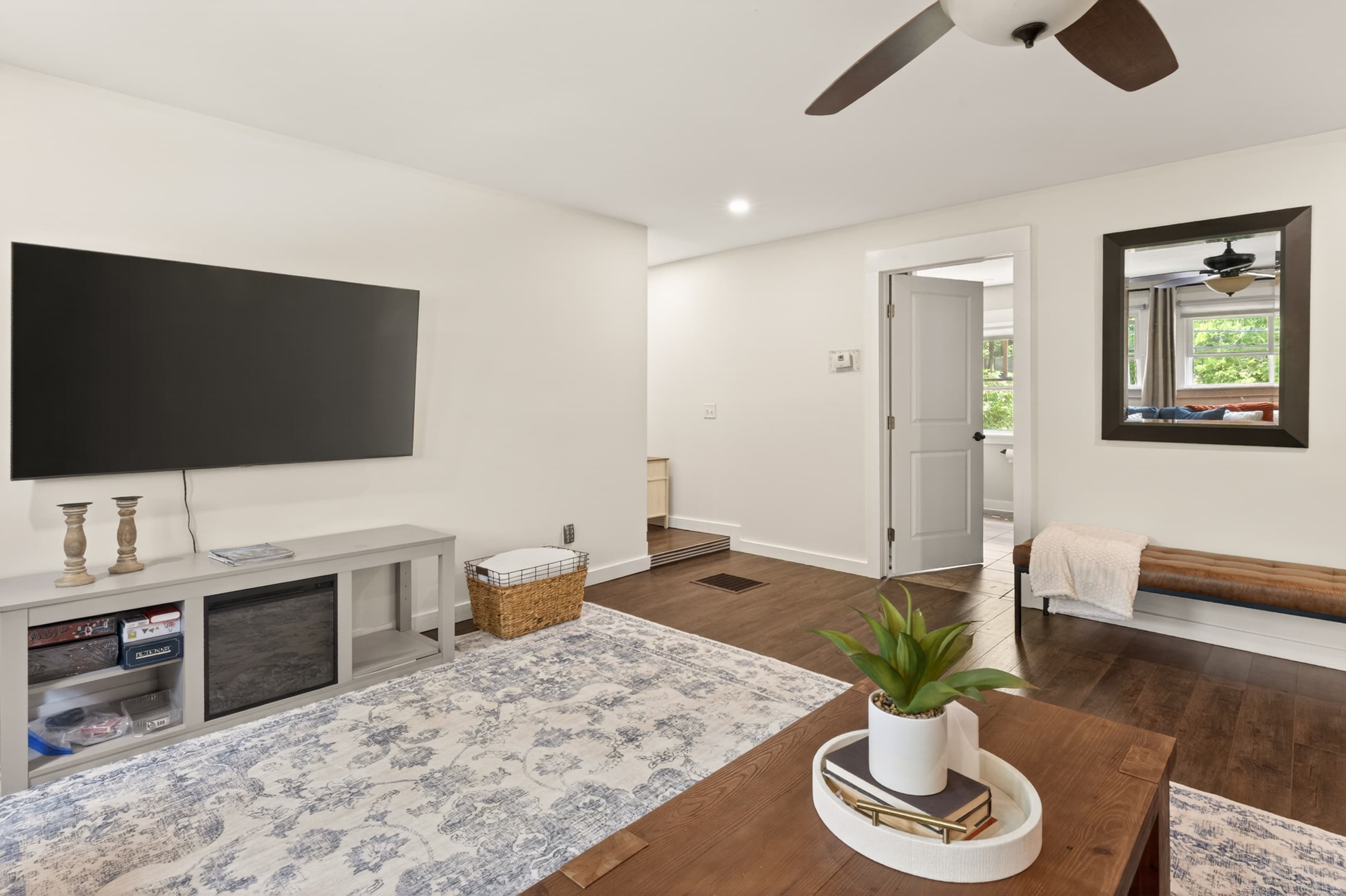 Lower-level living area with television and entry door