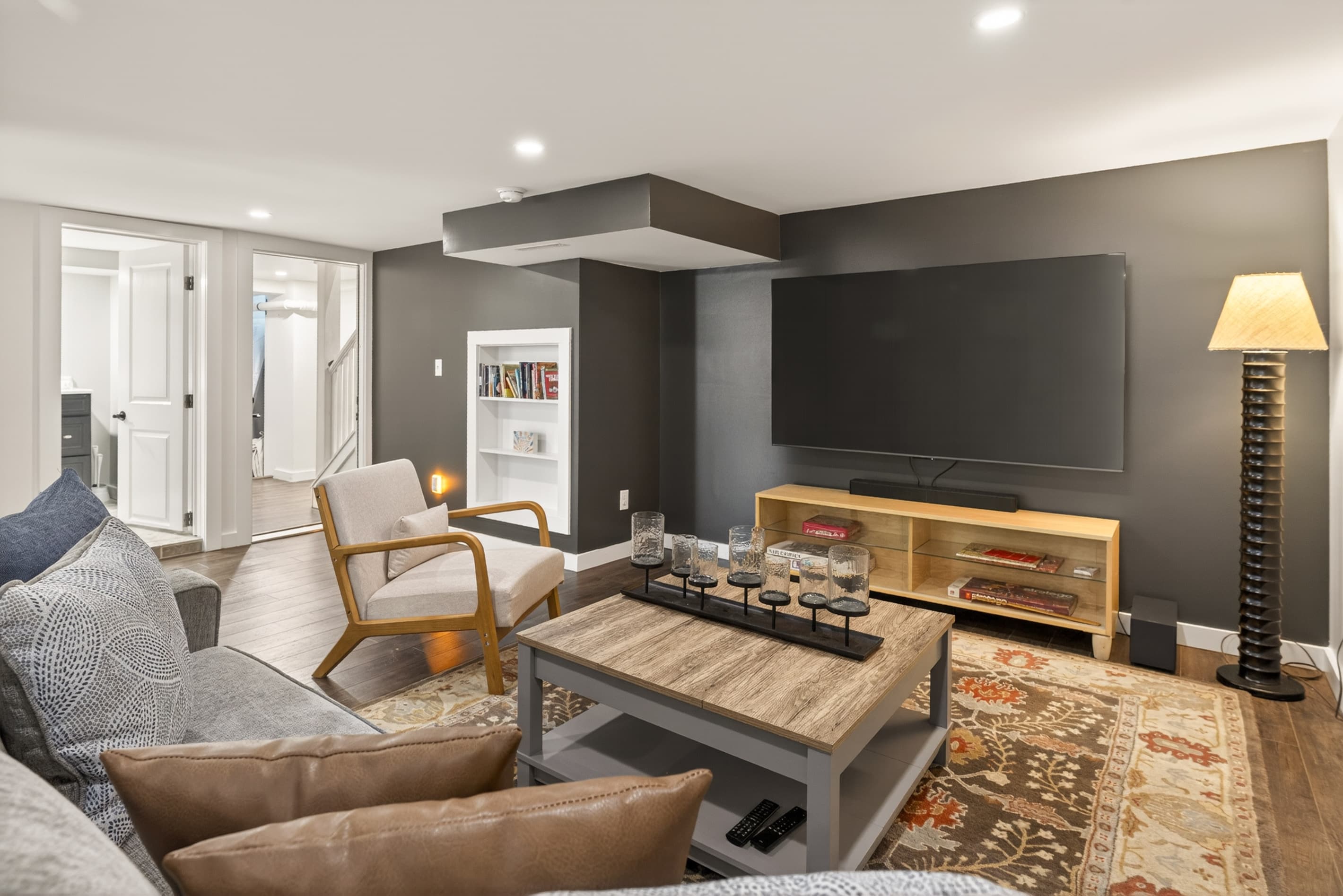 Lower-level lounge with sectional and floor lamp