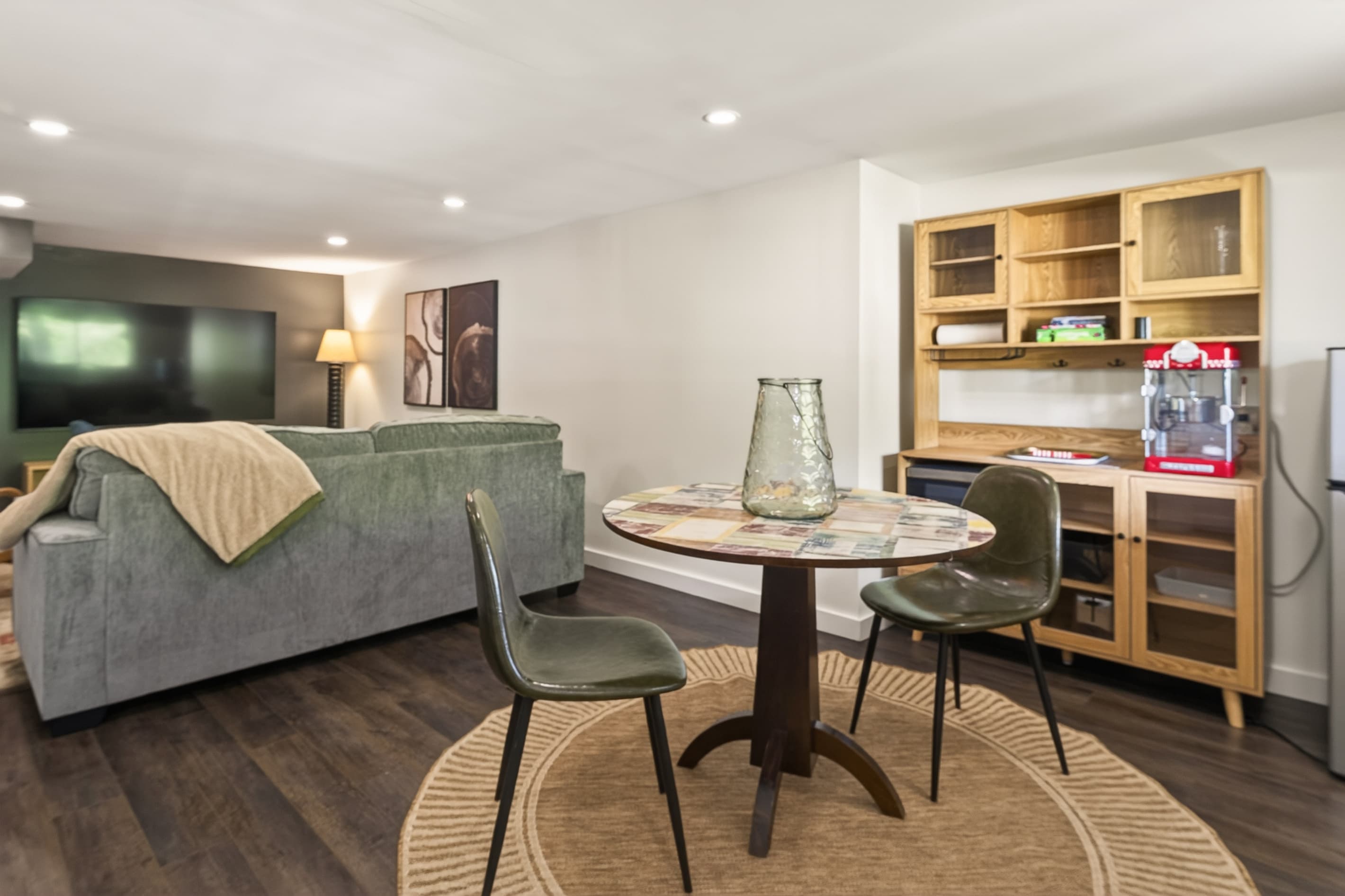 Round table beside built-in desk and shelving