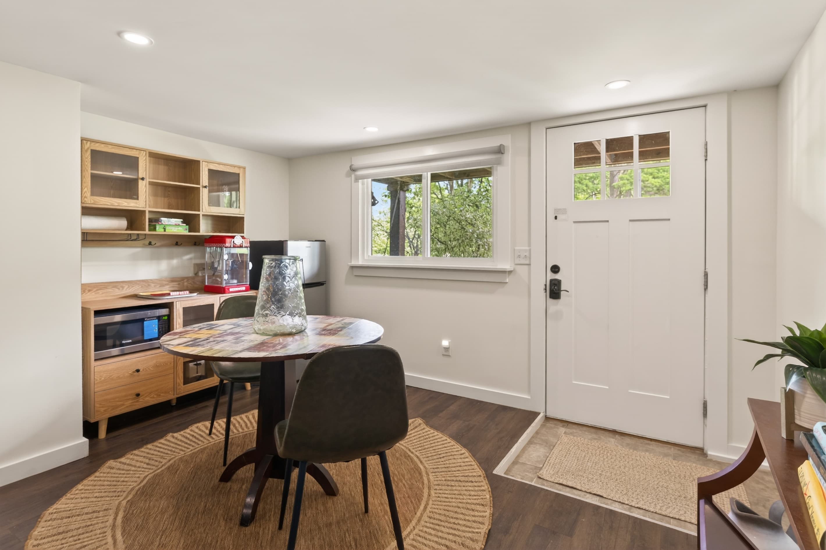 Small table beside built-in desk and exterior door