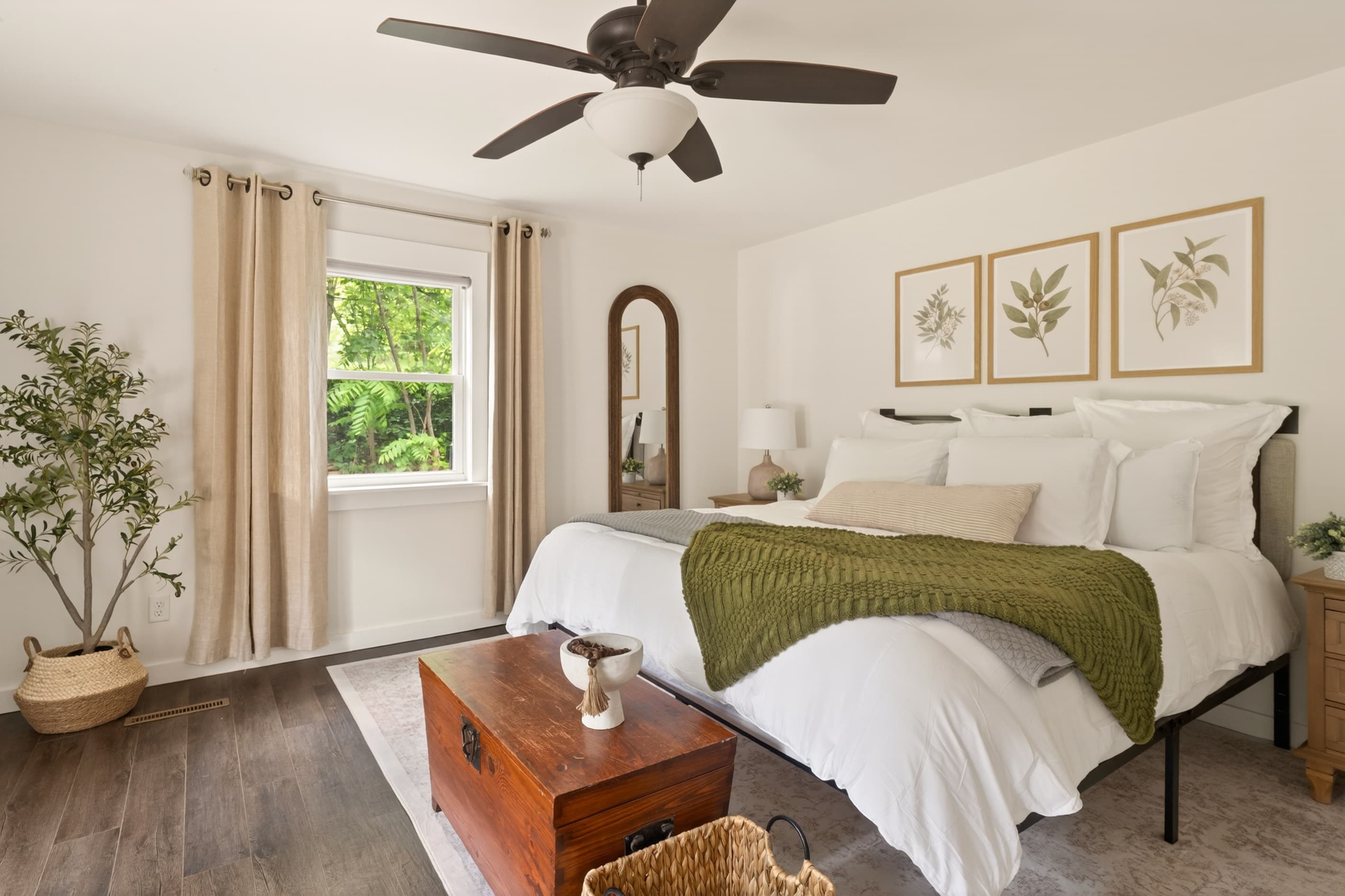 Bedroom with green throw and ceiling fan