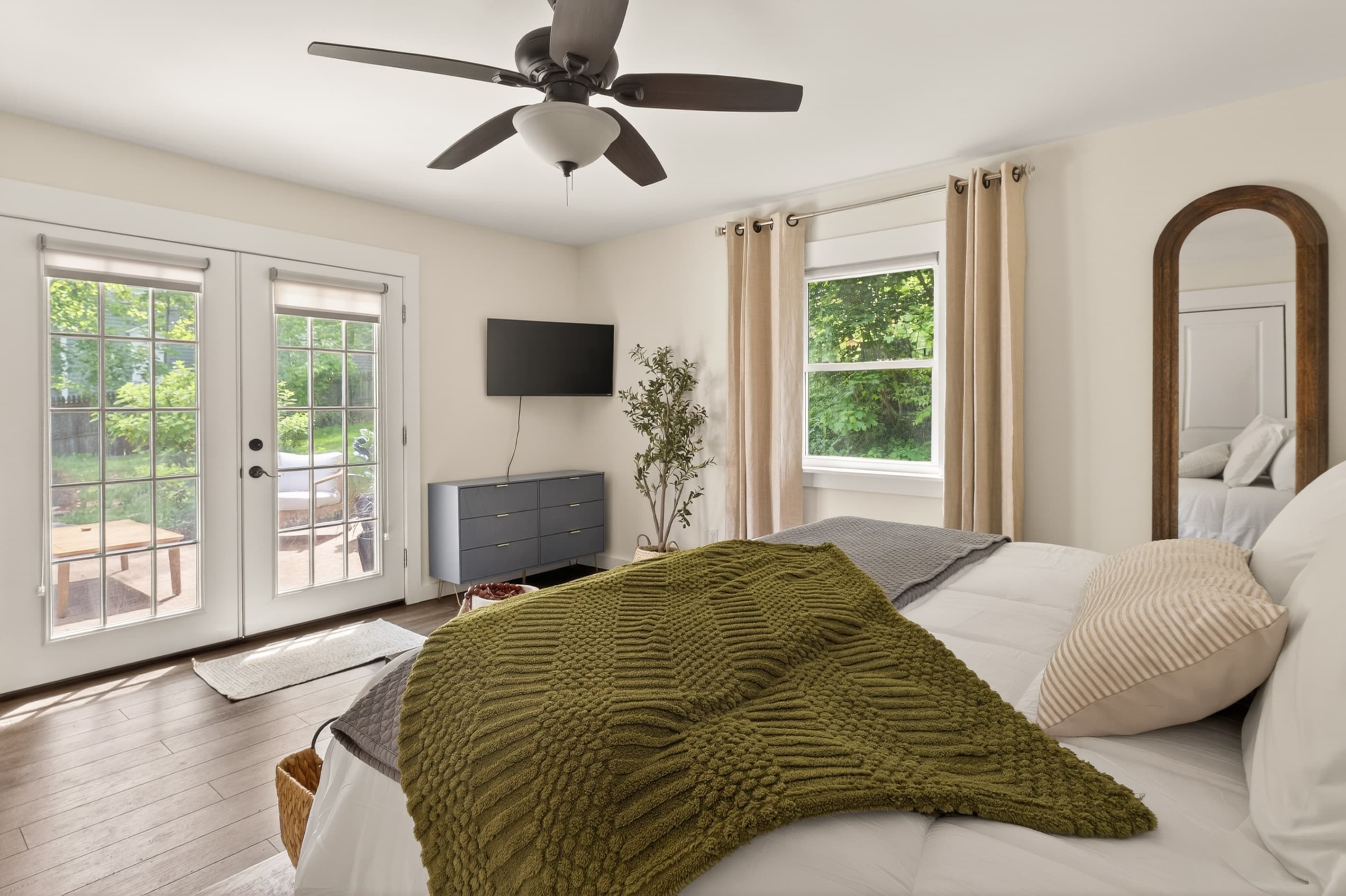 Bedroom with French doors and wall-mounted television