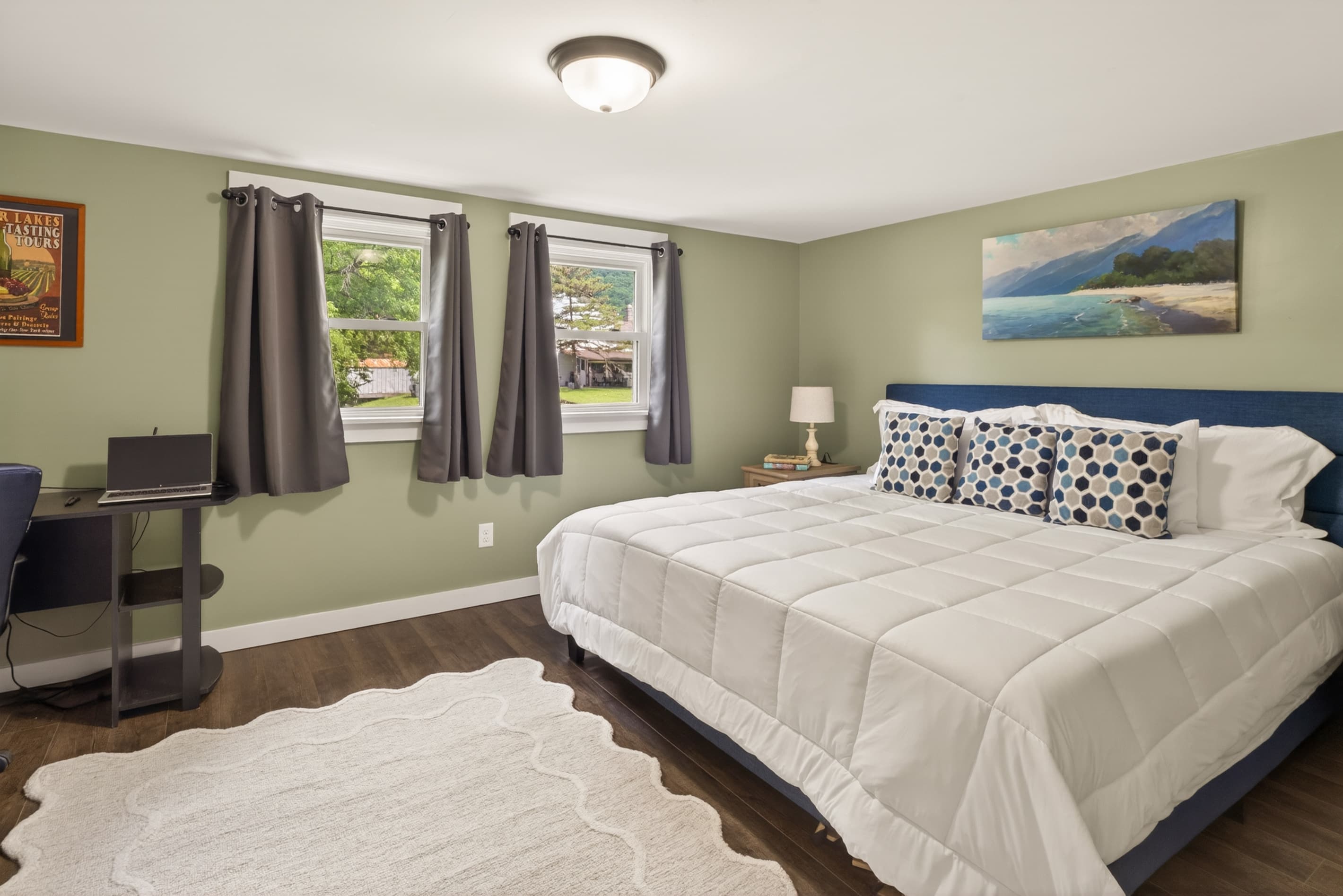 Bedroom with white bedding and windows