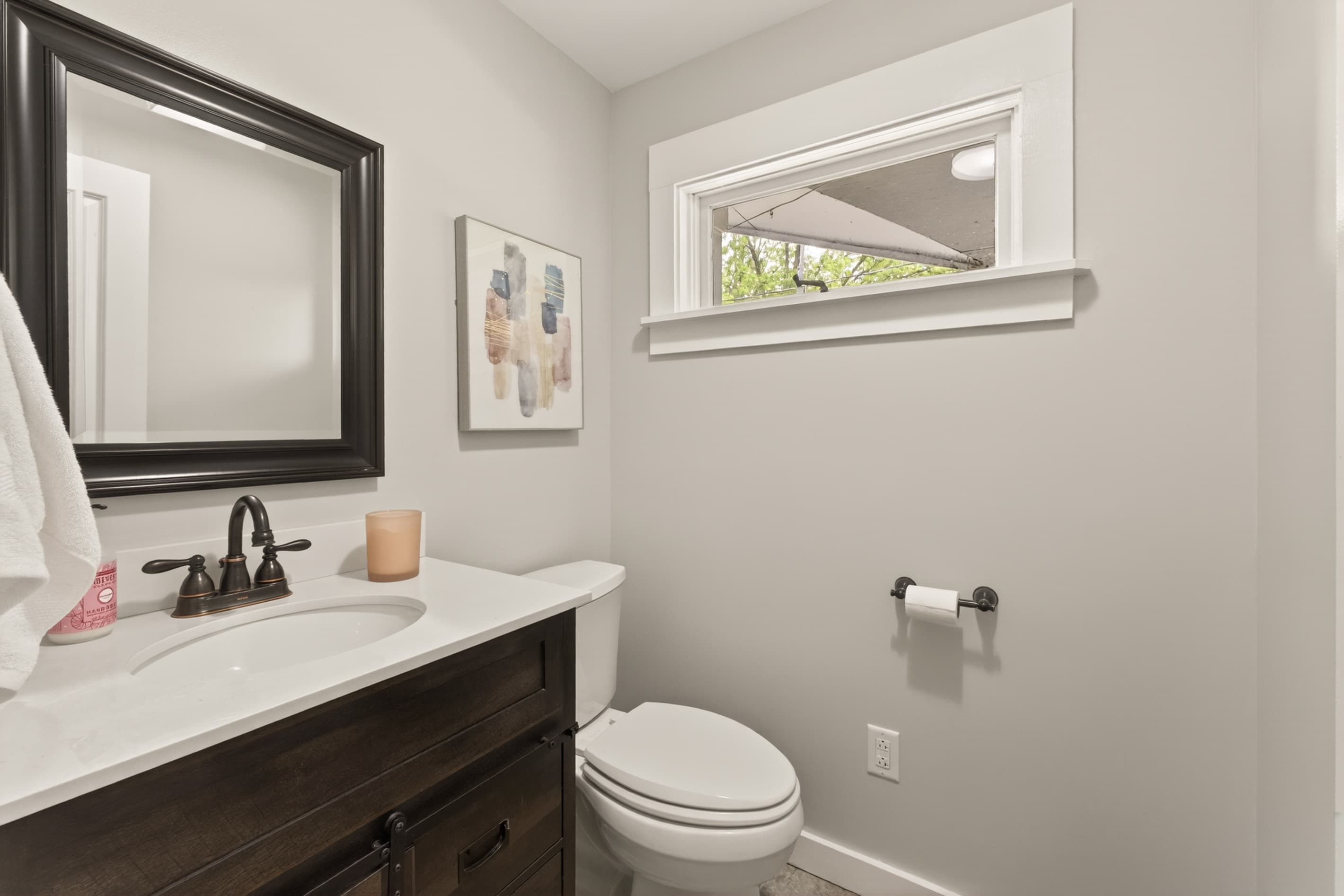 Half bathroom with vanity and toilet