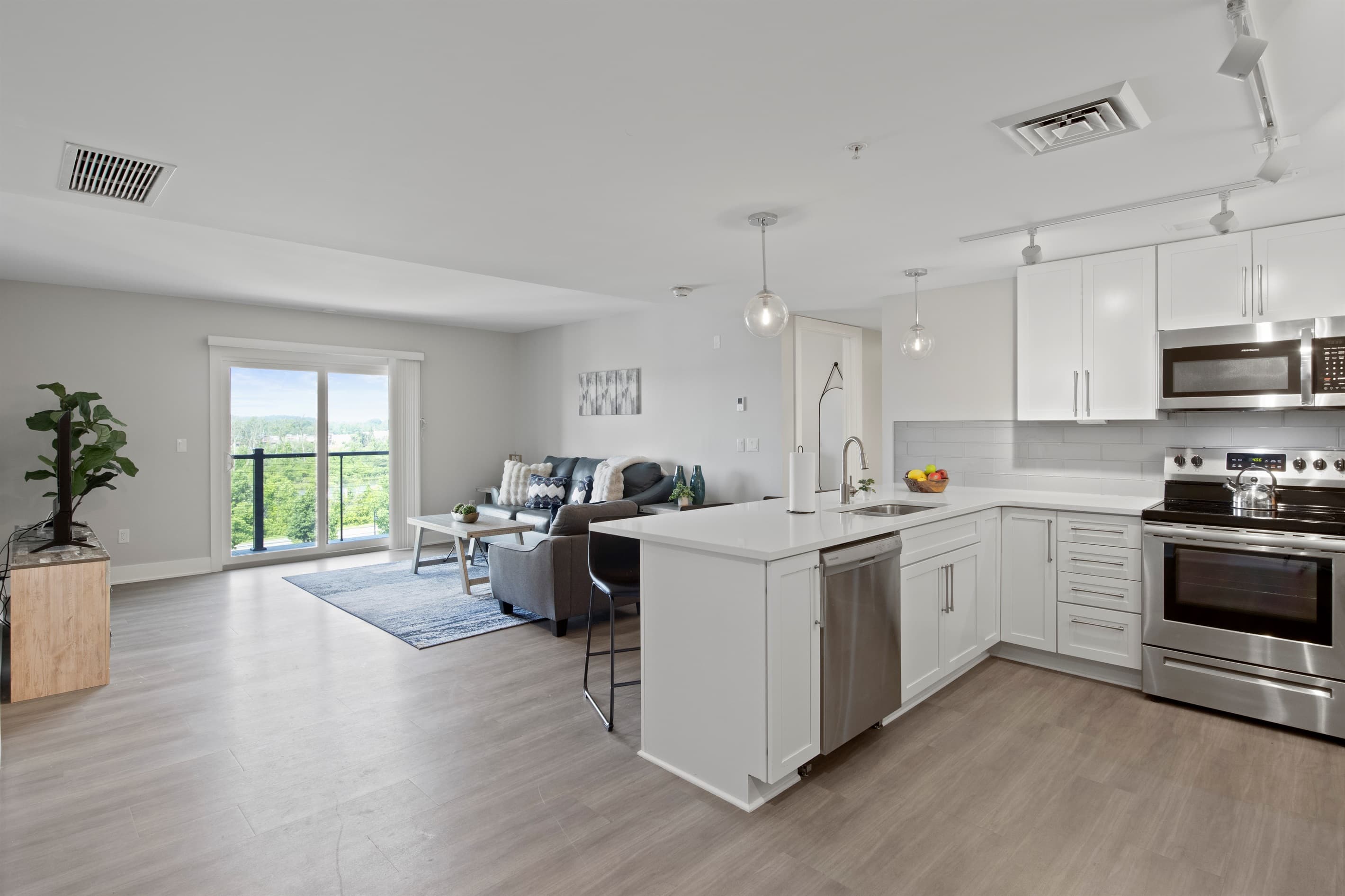 Open kitchen with breakfast bar and stainless steel appliances
