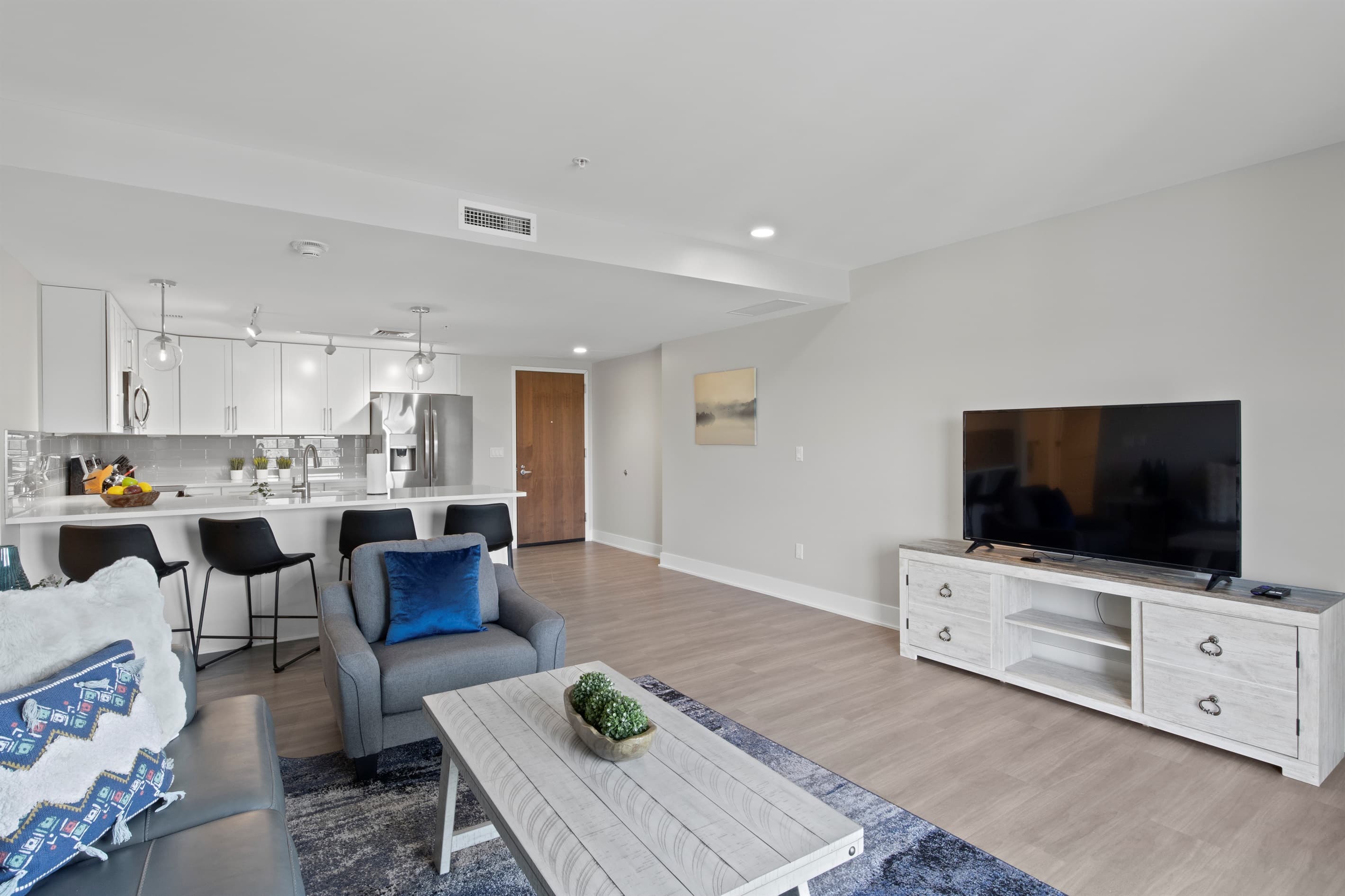 Open living area with television and kitchen access