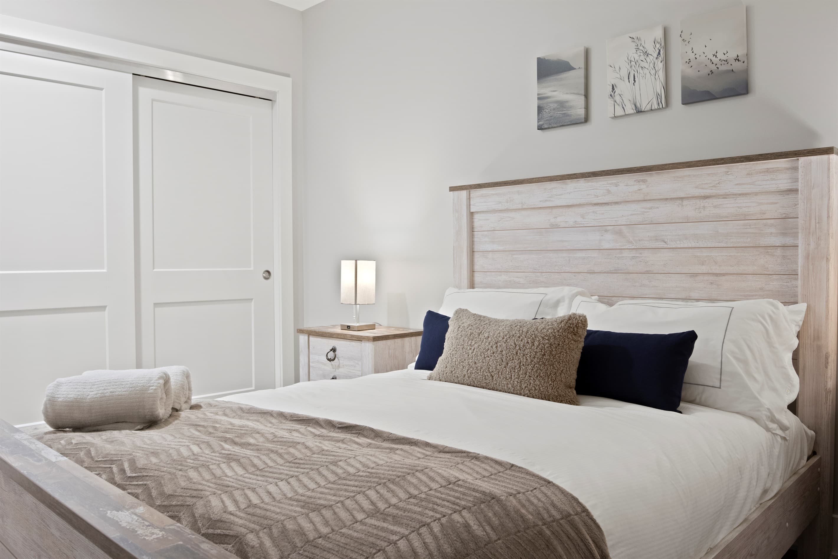 Guest bedroom with light wood bed frame