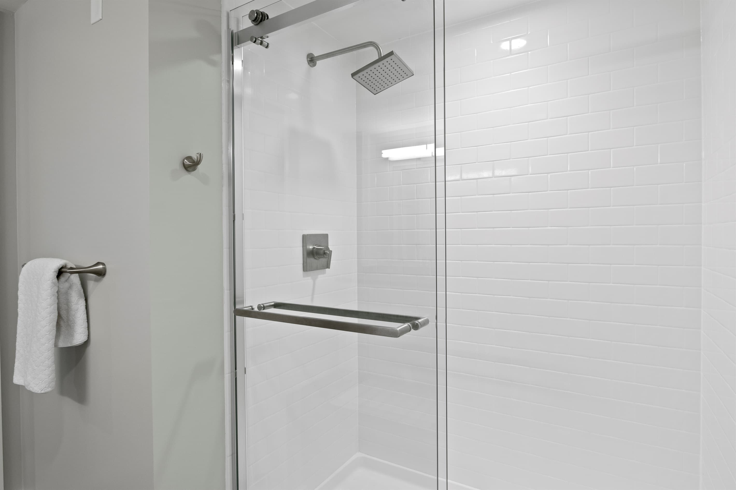 Glass-enclosed shower with modern fixtures