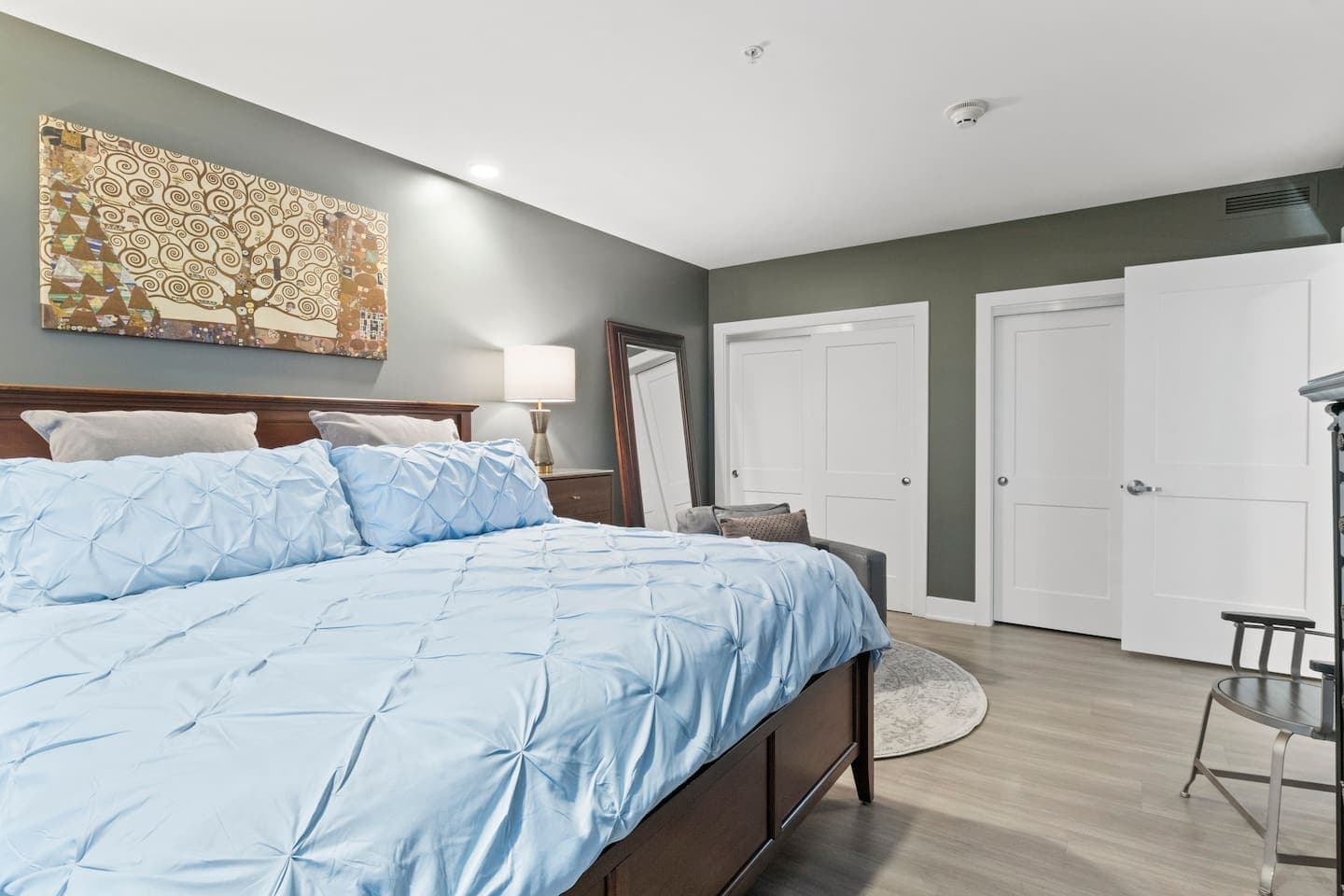 Bedroom with blue bedding and artwork 