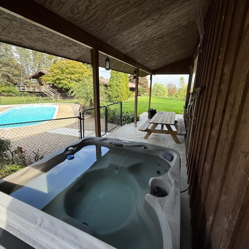 Covered outdoor hot tub overlooking the yard