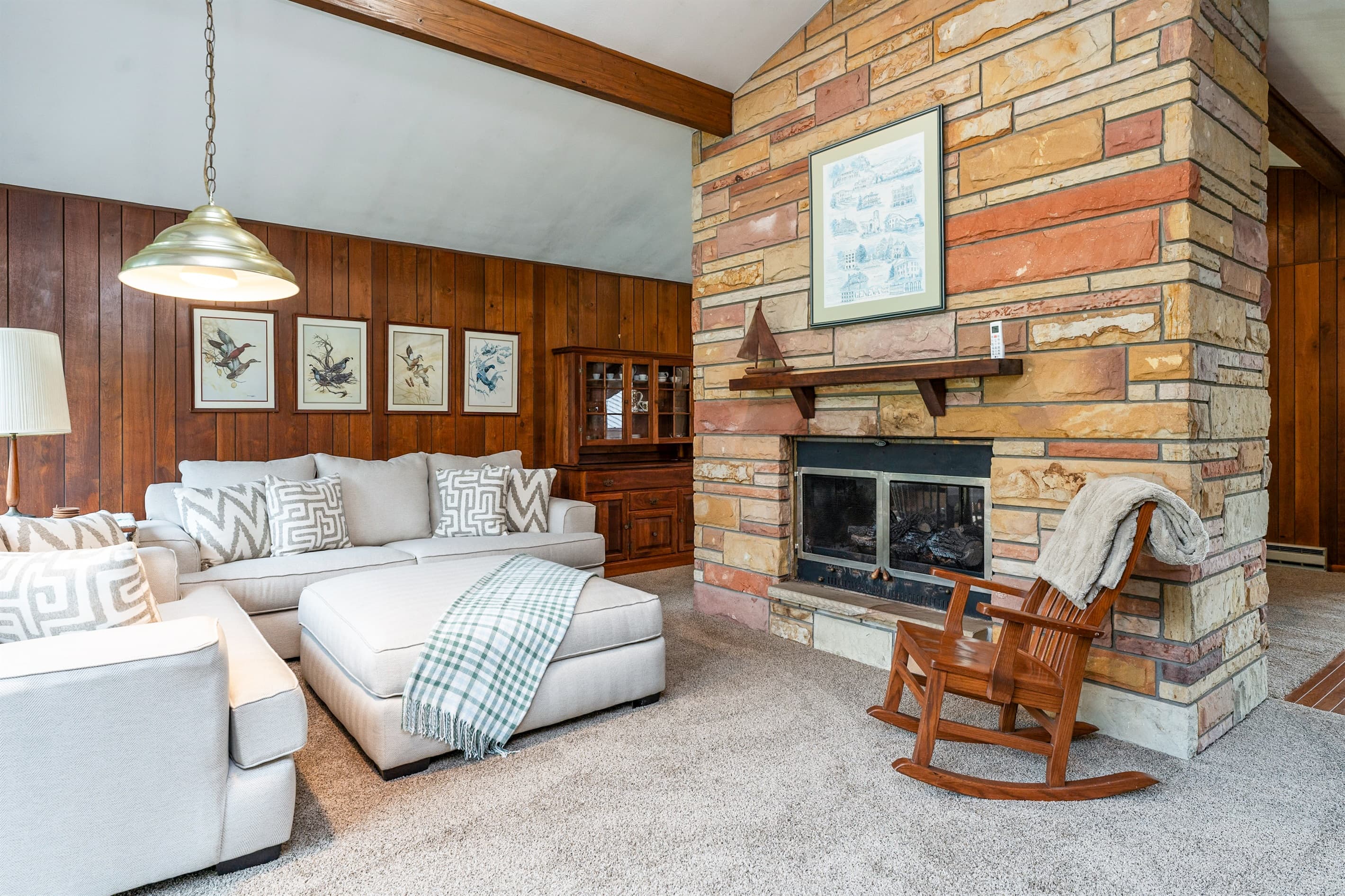 Living room with stone fireplace and sectional