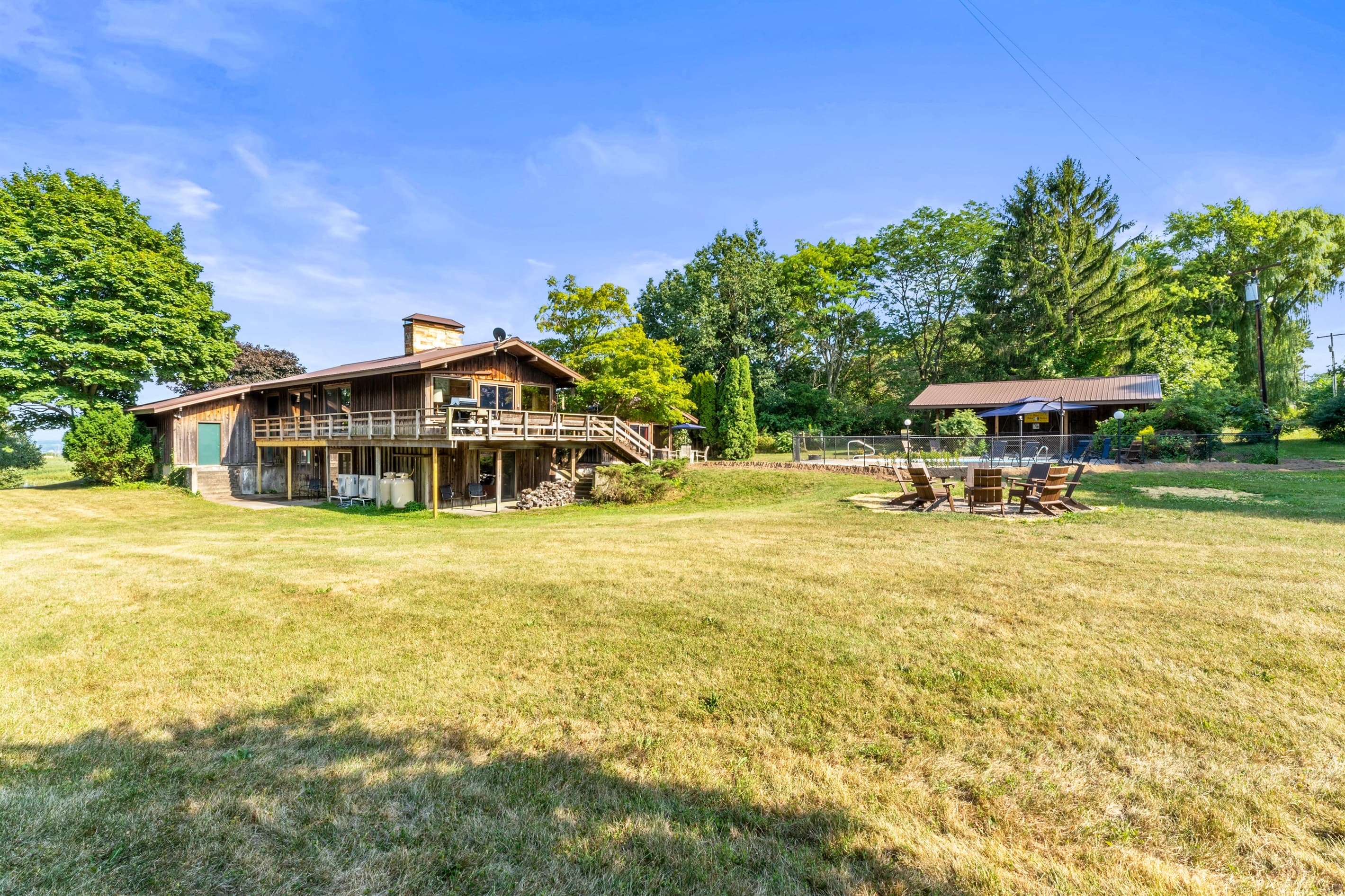 Rear lawn with deck and fire pit