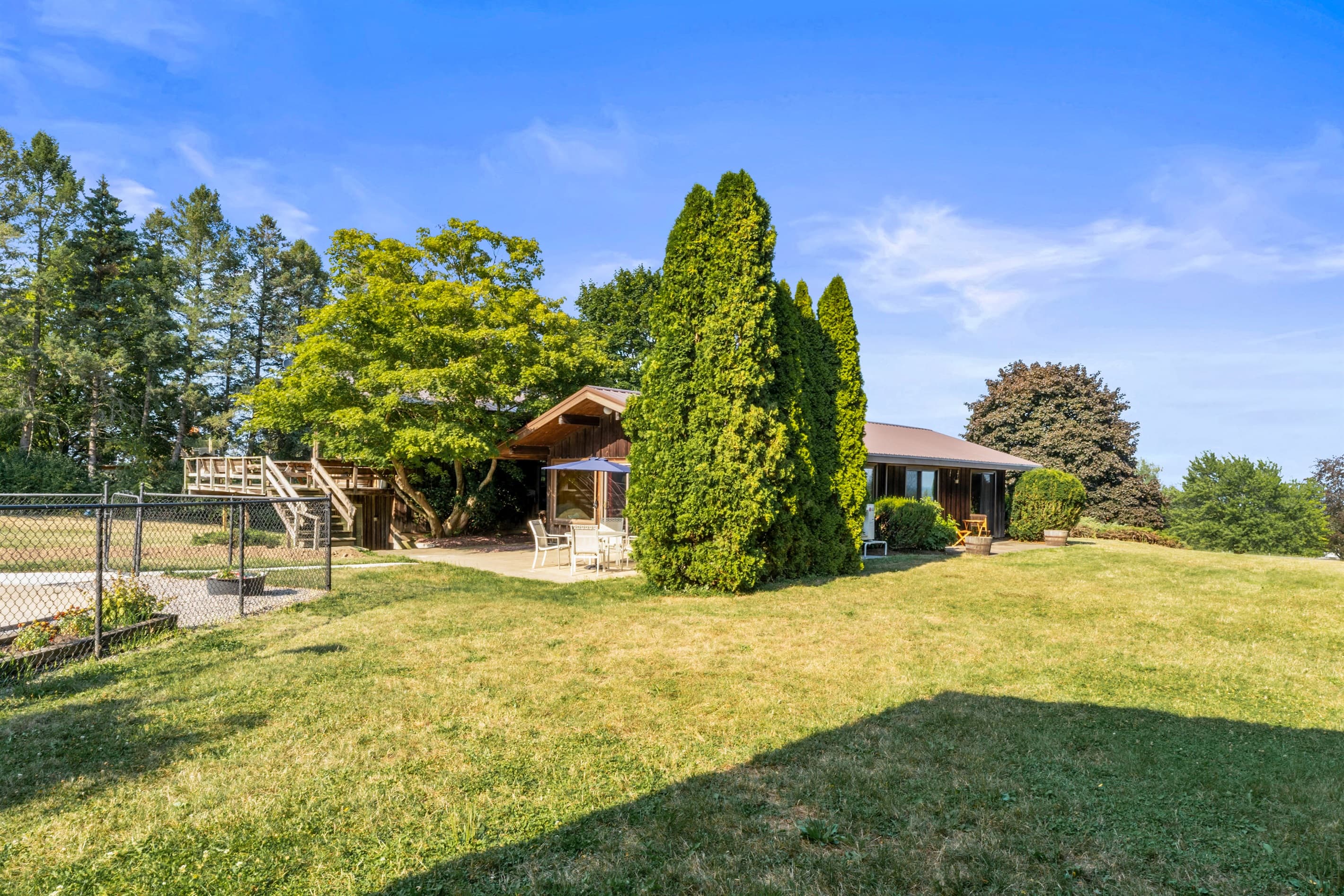 Spacious yard bordered by mature trees