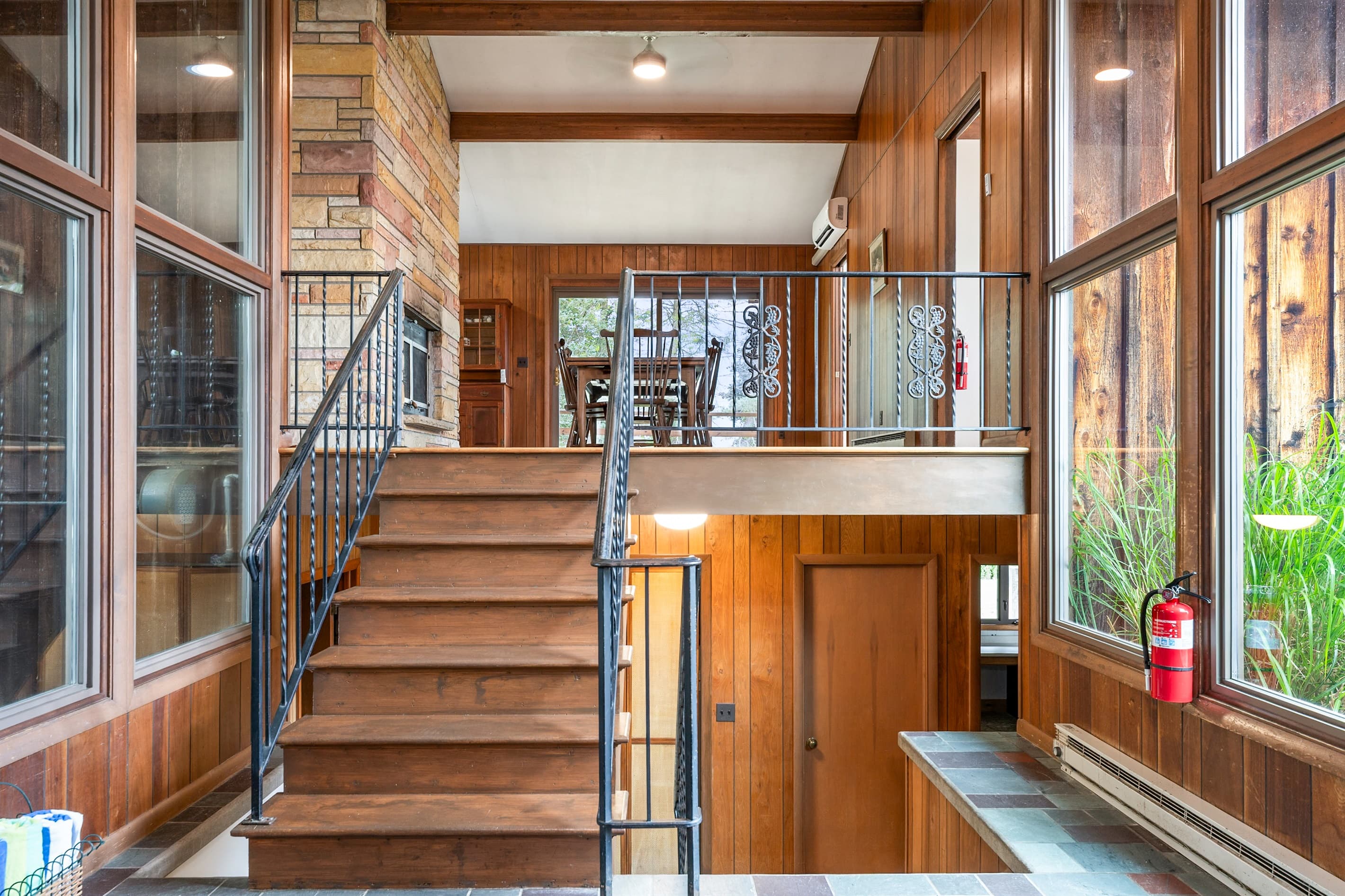 Entryway with staircase and floor-to-ceiling windows