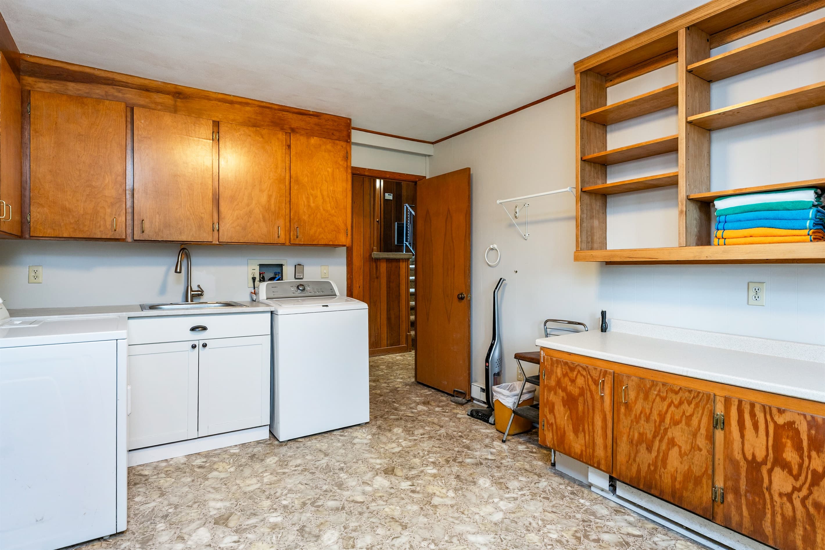 Laundry room with utility sink and cabinetry