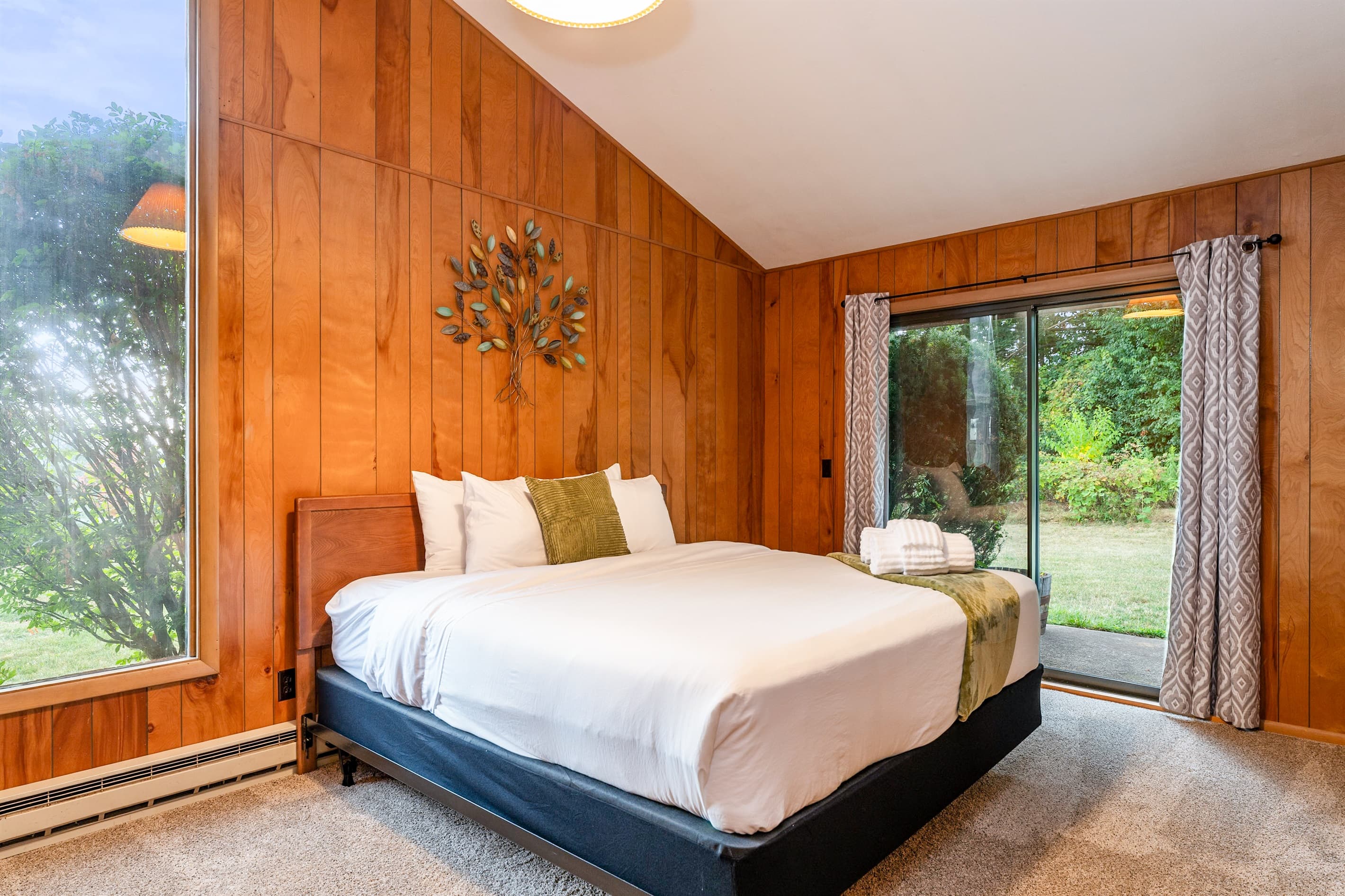 Bedroom with large windows and sliding doors
