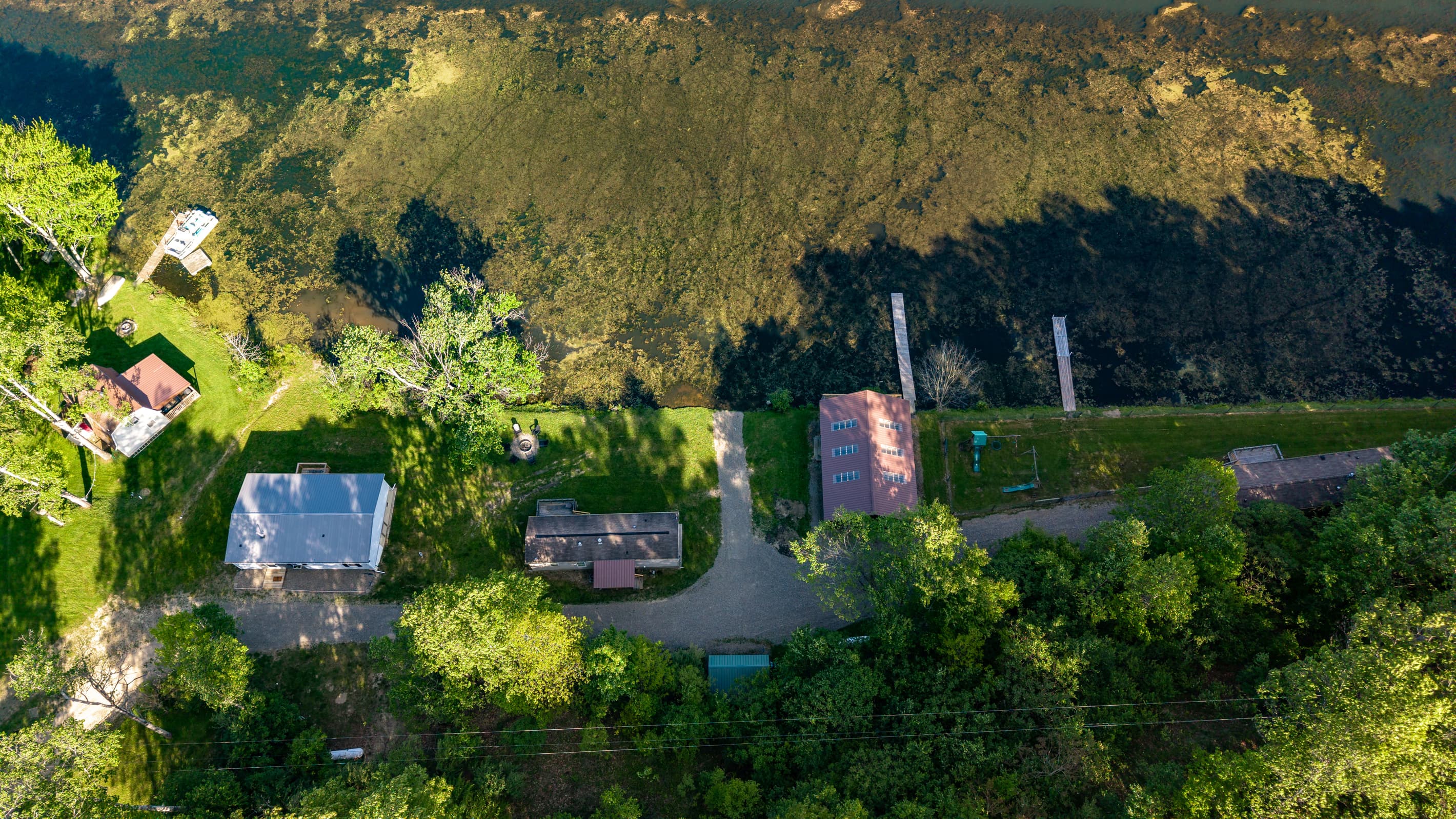 Aerial view of three wooded cabins