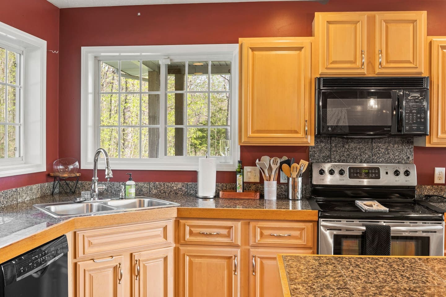 Cooking area with gas range and tiled backsplash