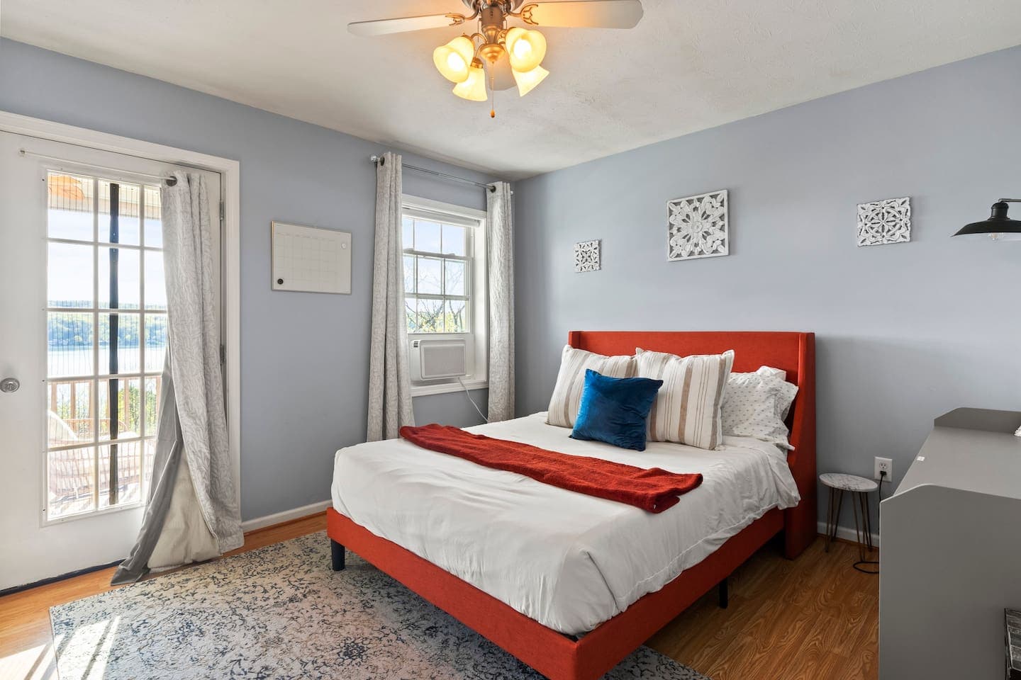 King bedroom with glass door leading to the deck