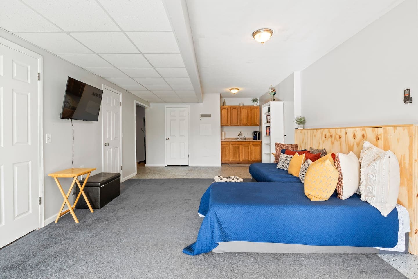 Basement lounge with kitchenette and television