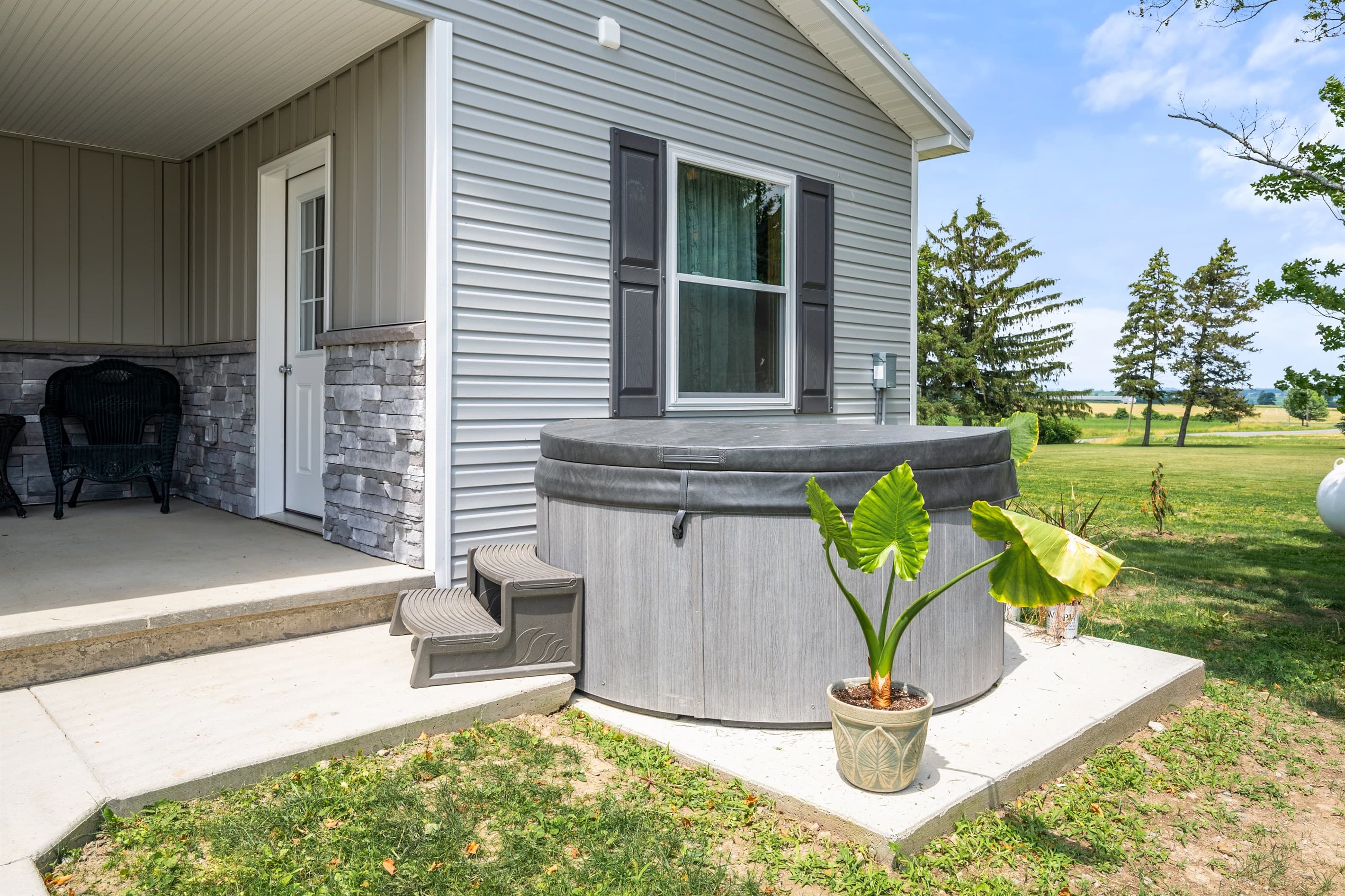 Hot tub positioned beside the house