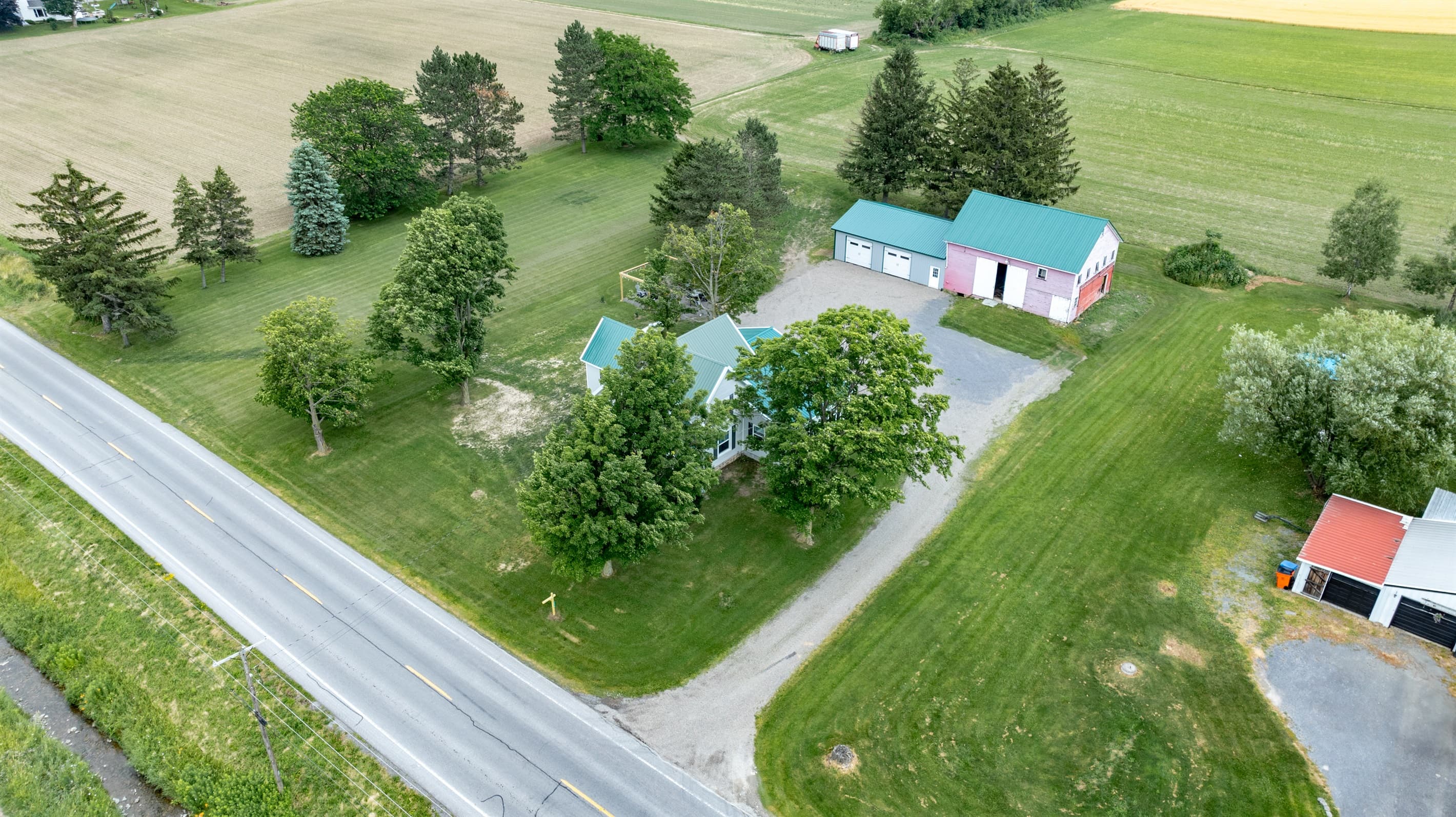 Property surrounded by open fields and trees