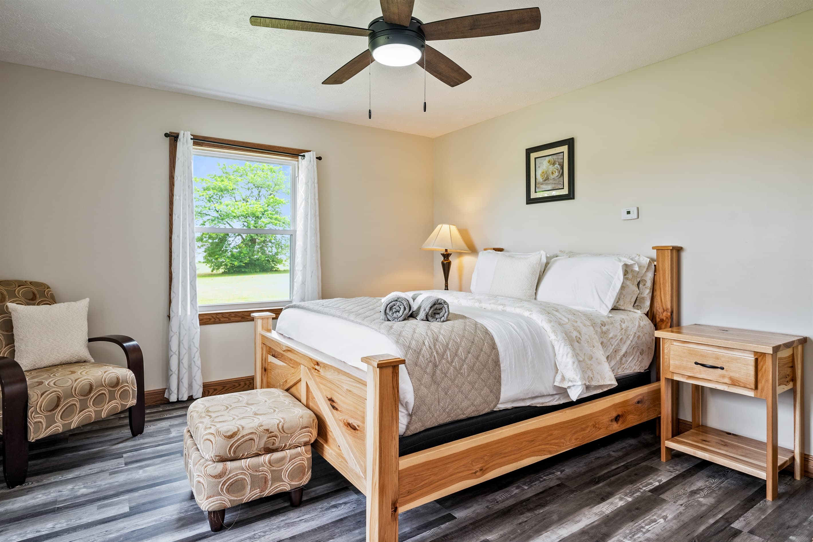 Bright bedroom with ceiling fan and window