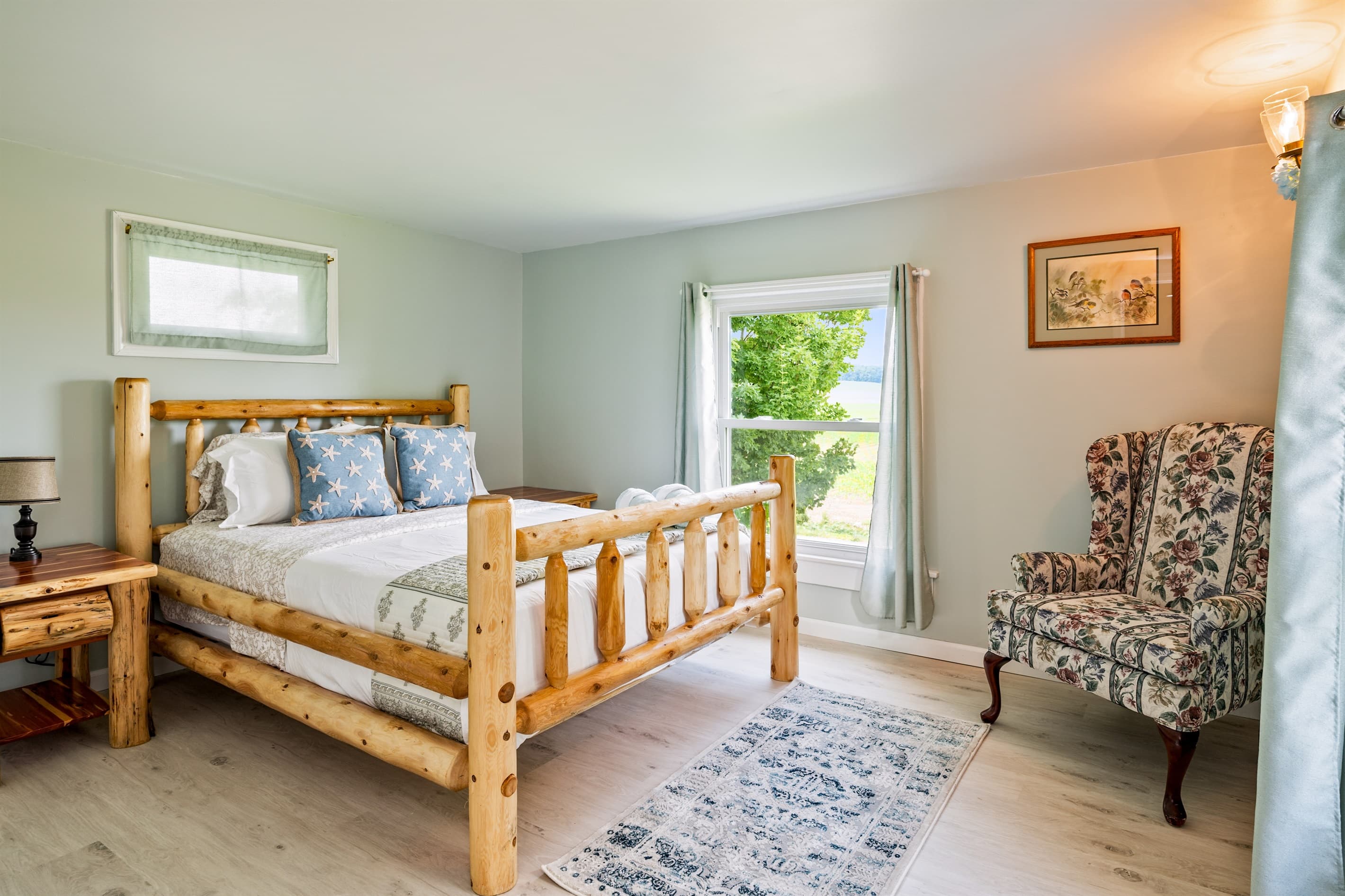 Bedroom with wooden bed and floral armchair