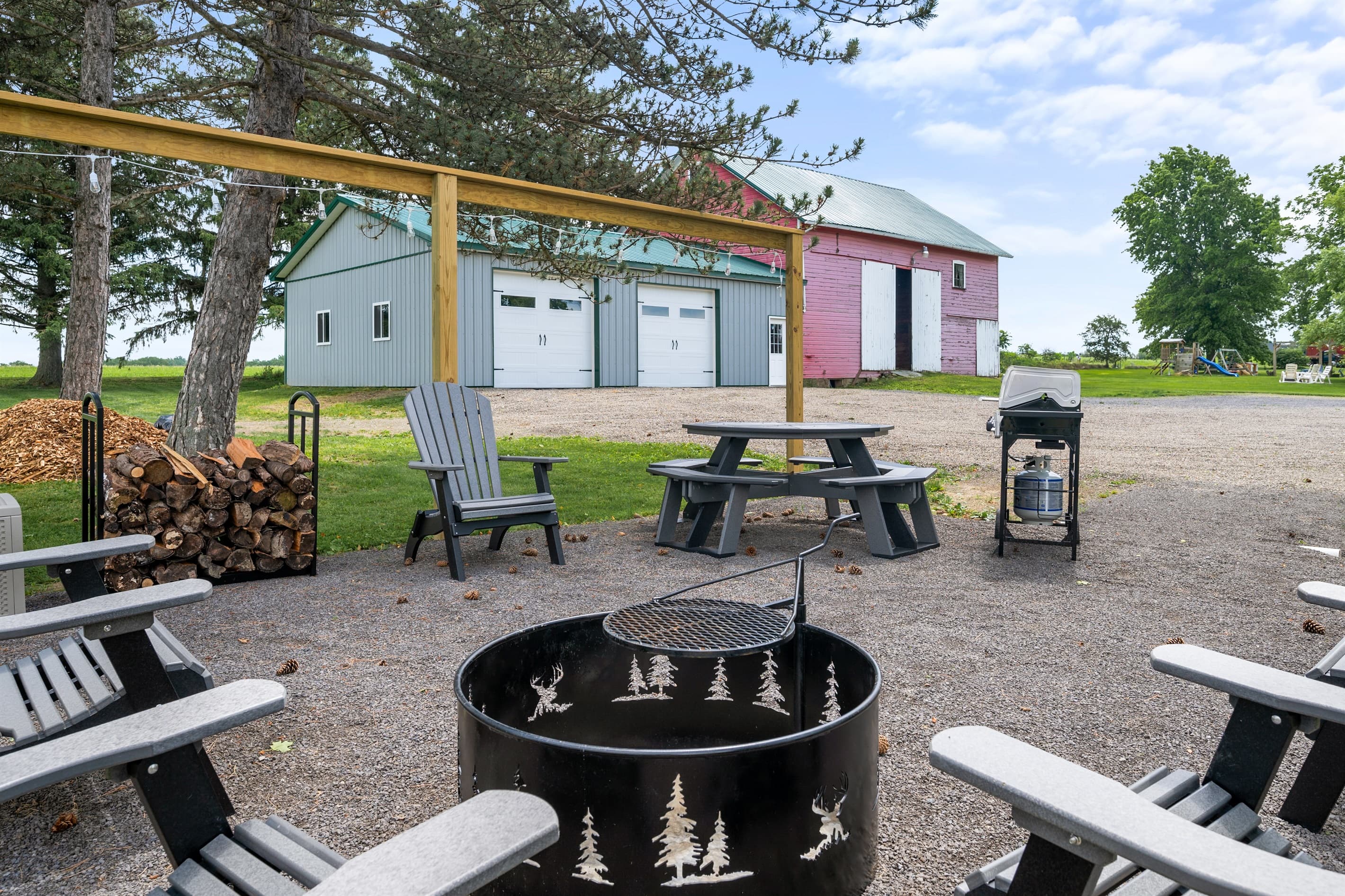 Fire pit and grill beside the farmhouse