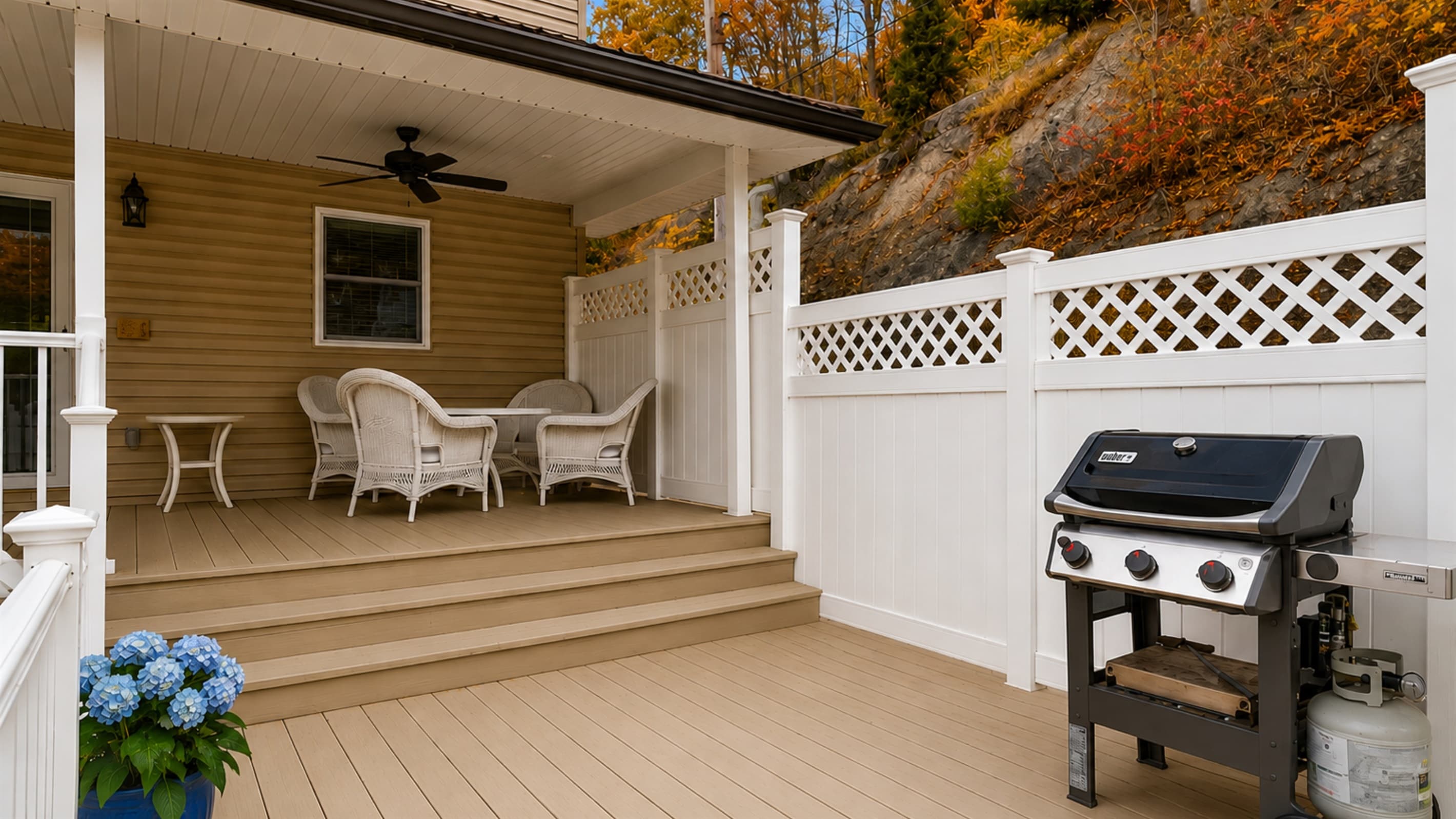 Gas grill beside the porch railing