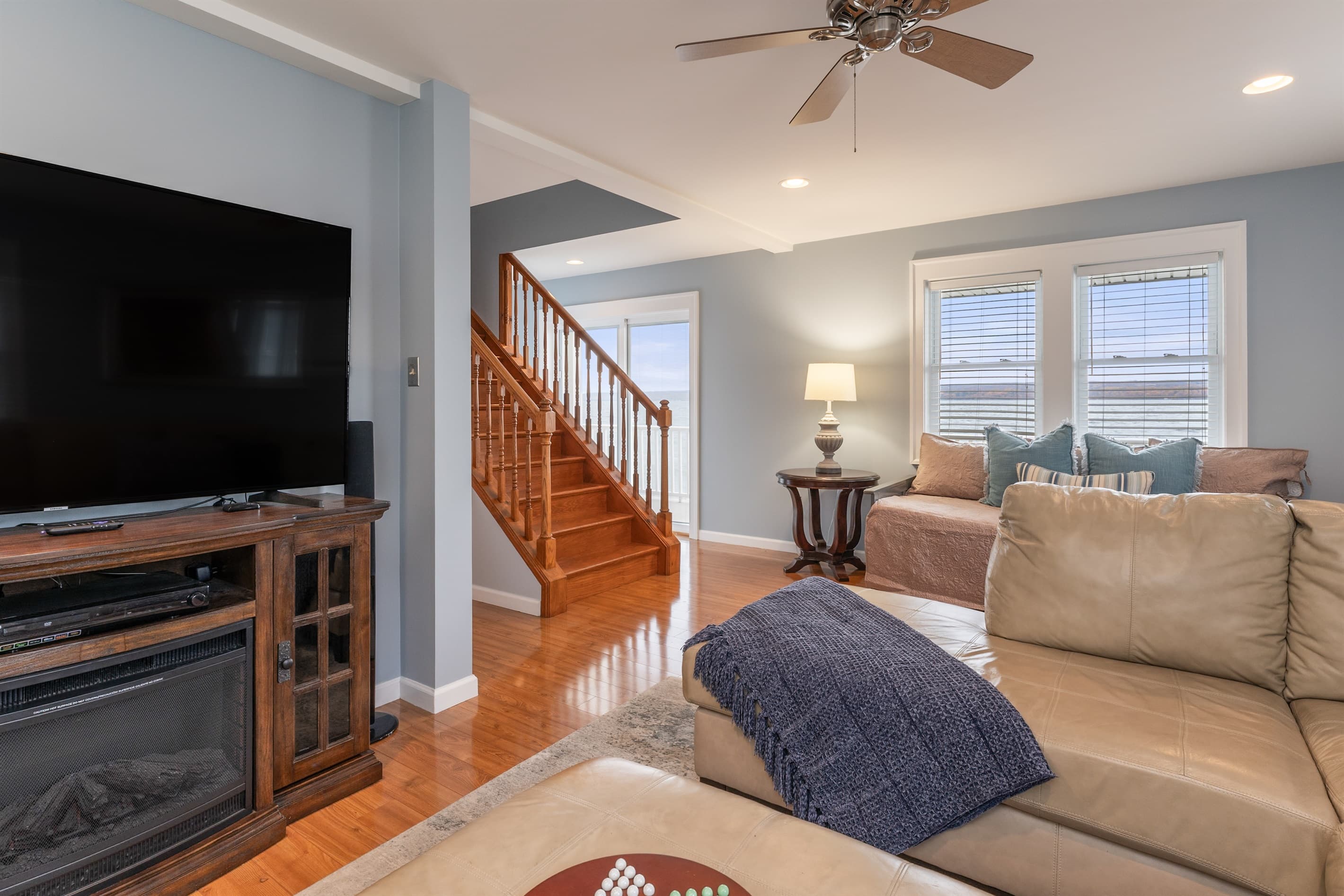 Living area beside the wooden staircase