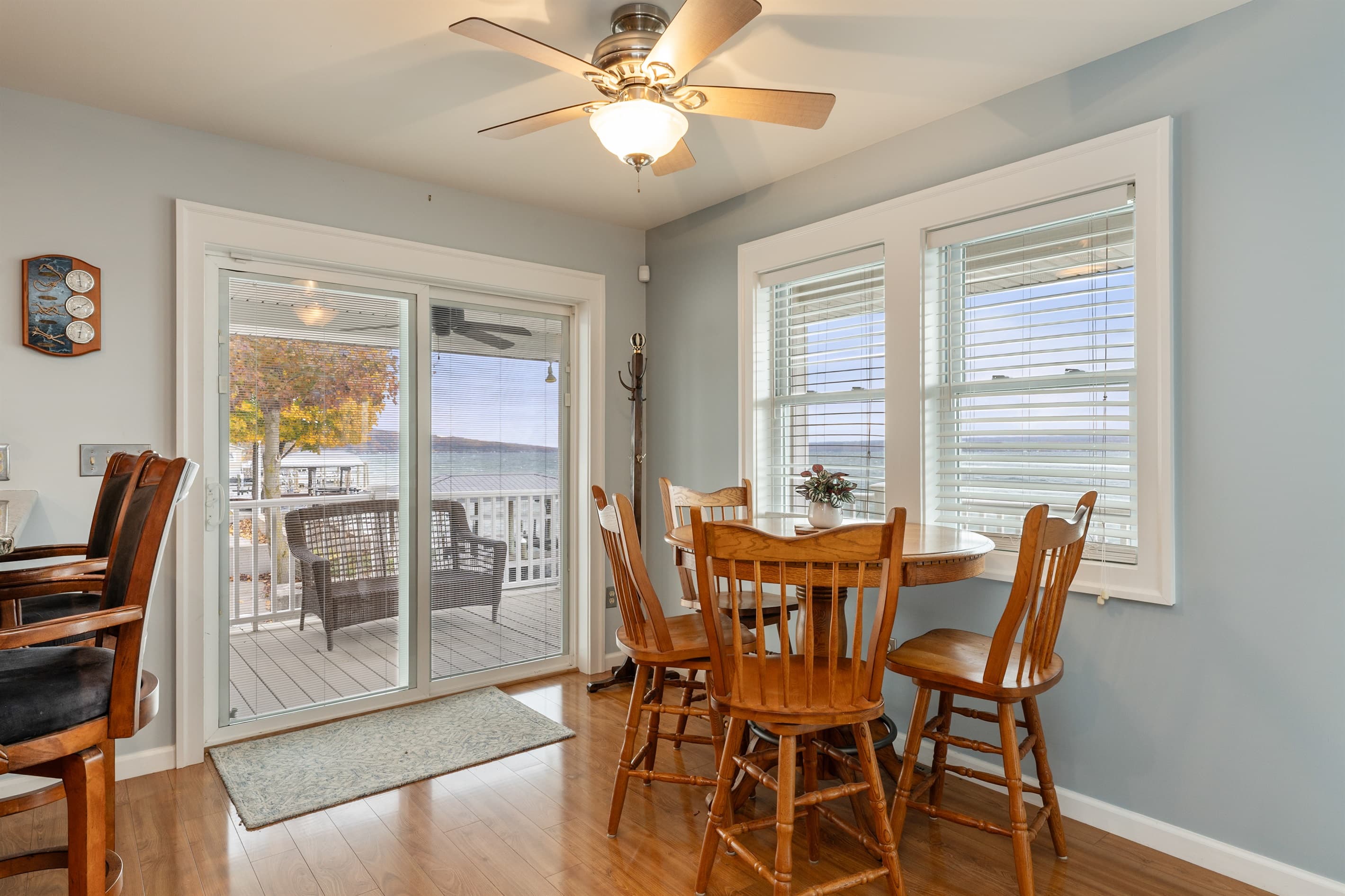 Dining table surrounded by lake-facing windows