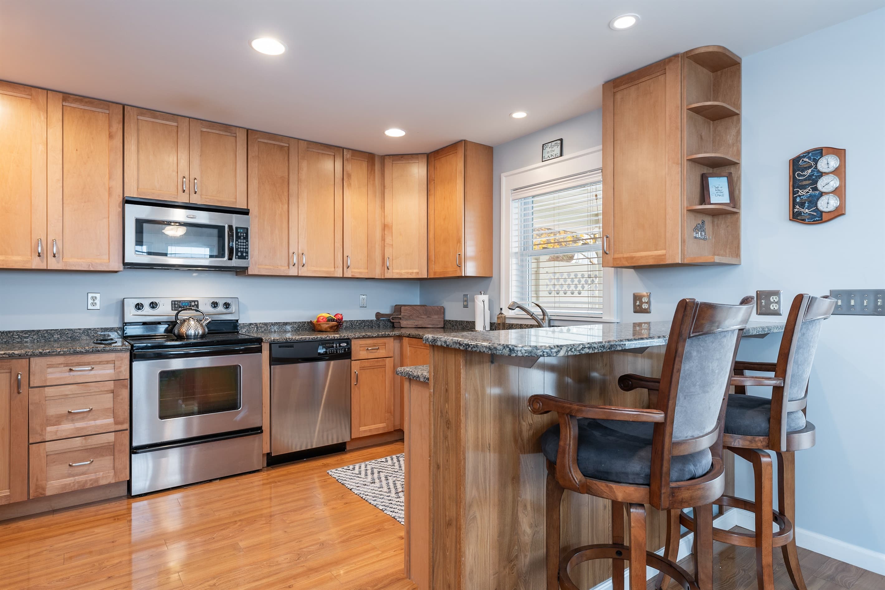 Kitchen with breakfast bar and wooden cabinetry