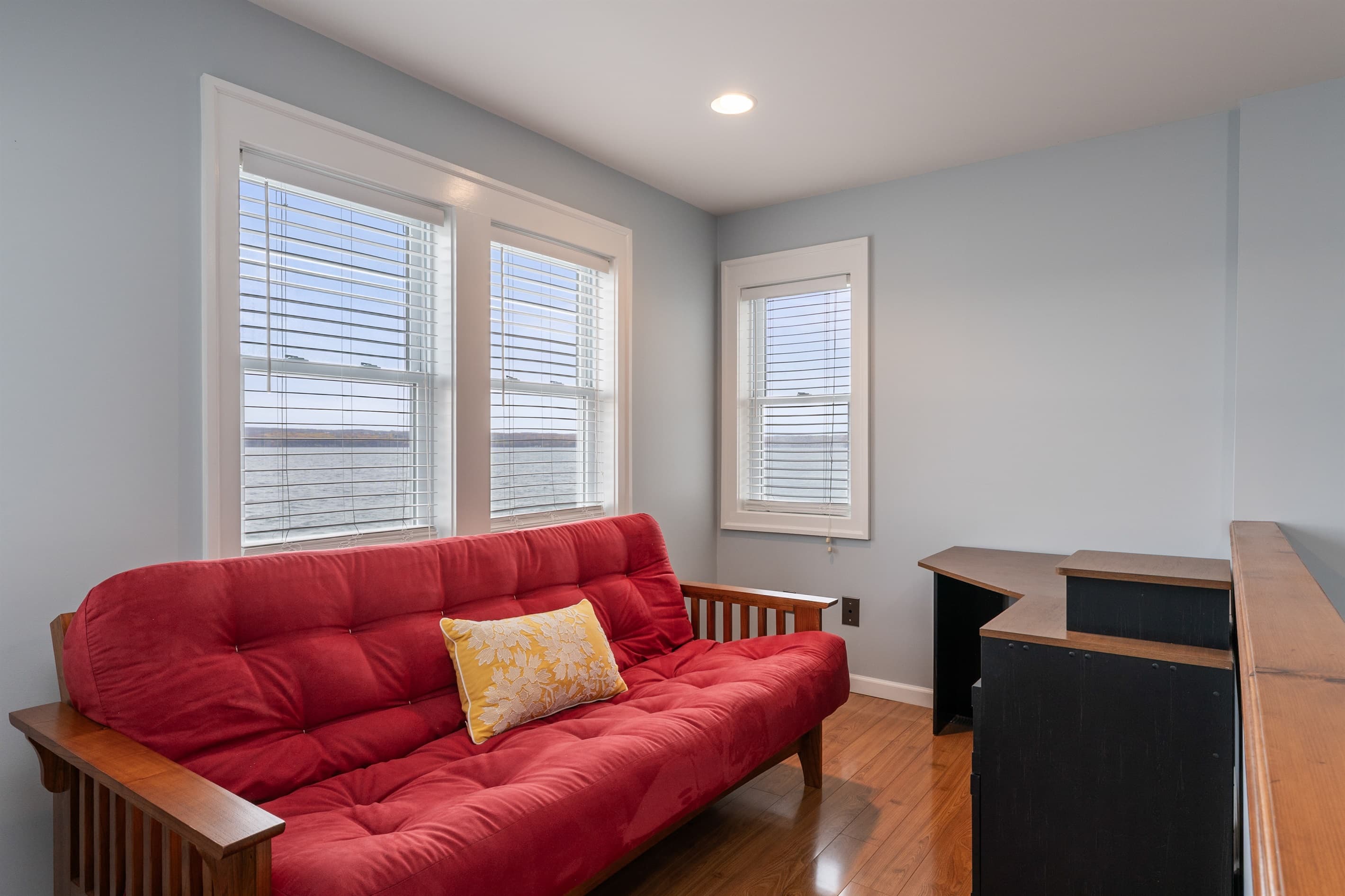 Red futon beside the upstairs windows