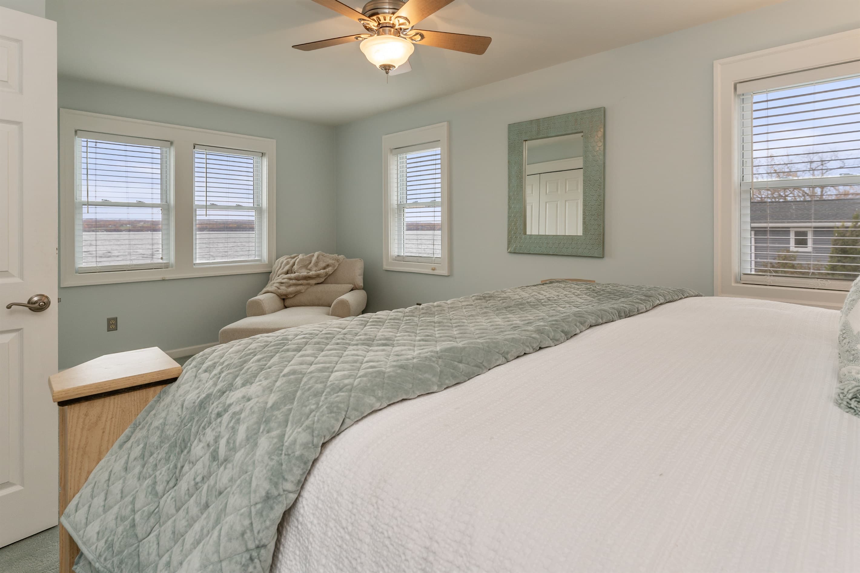 King bedroom with ceiling fan and dresser