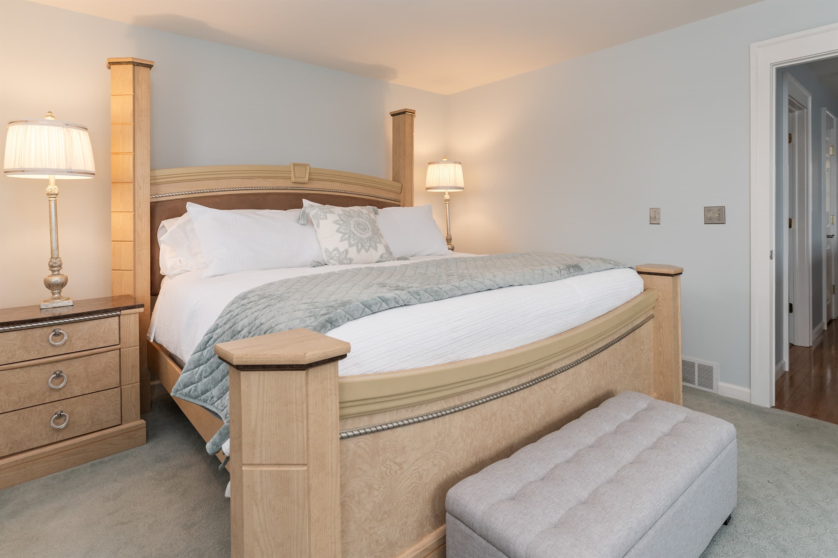 King bed beneath wooden ceiling beams