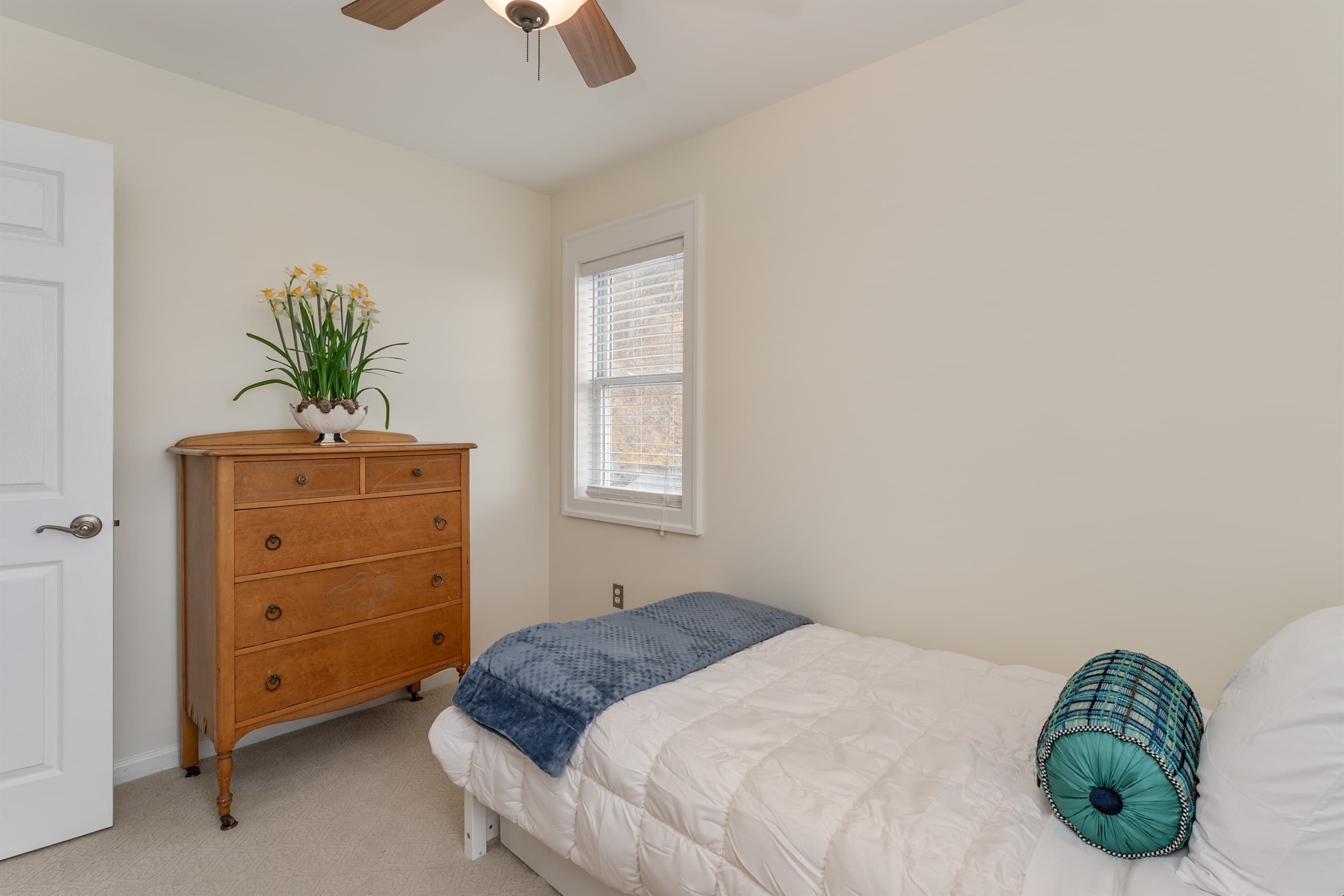 Twin bedroom with dresser and window