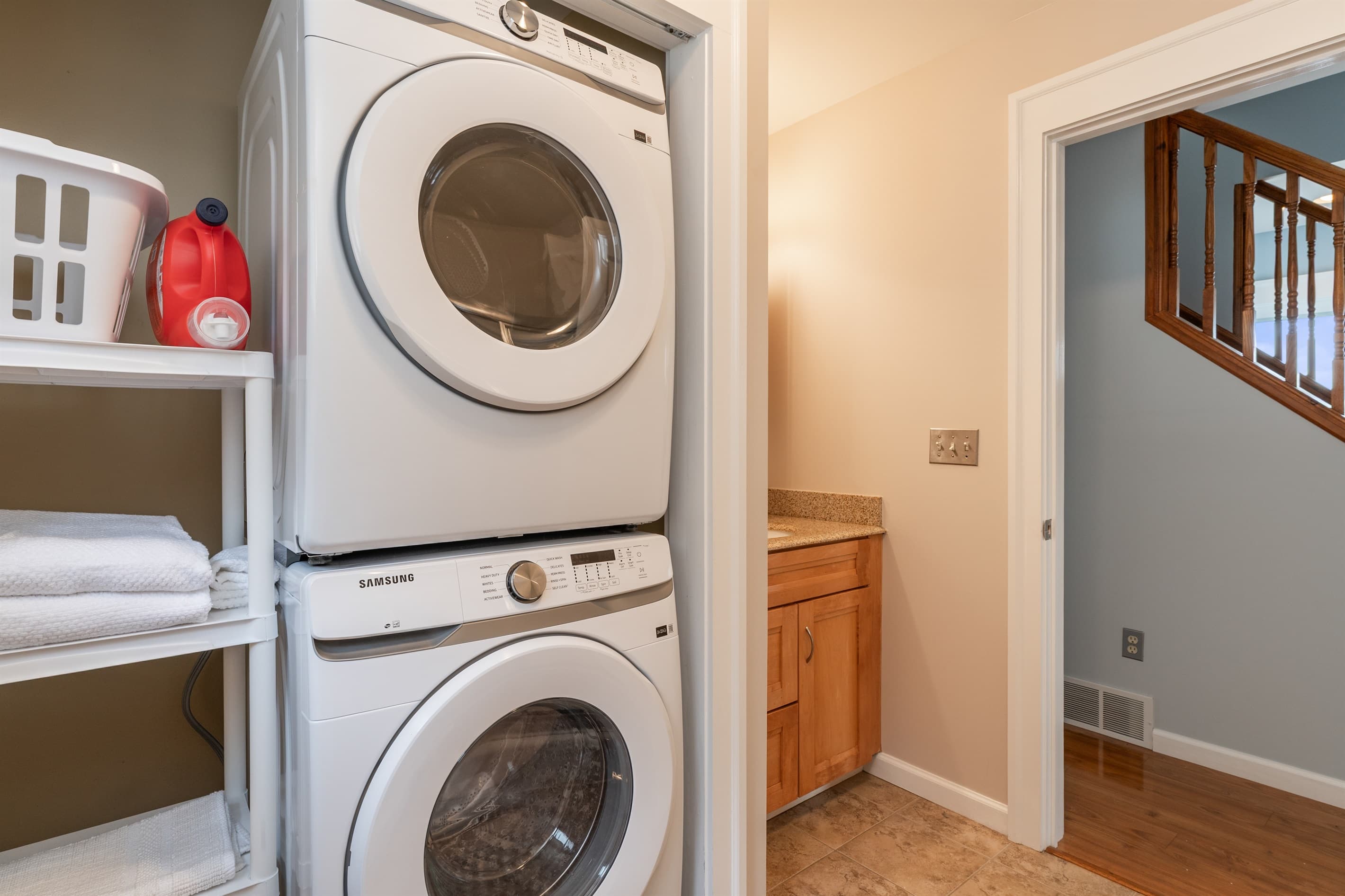Stacked washer and dryer near the stairs