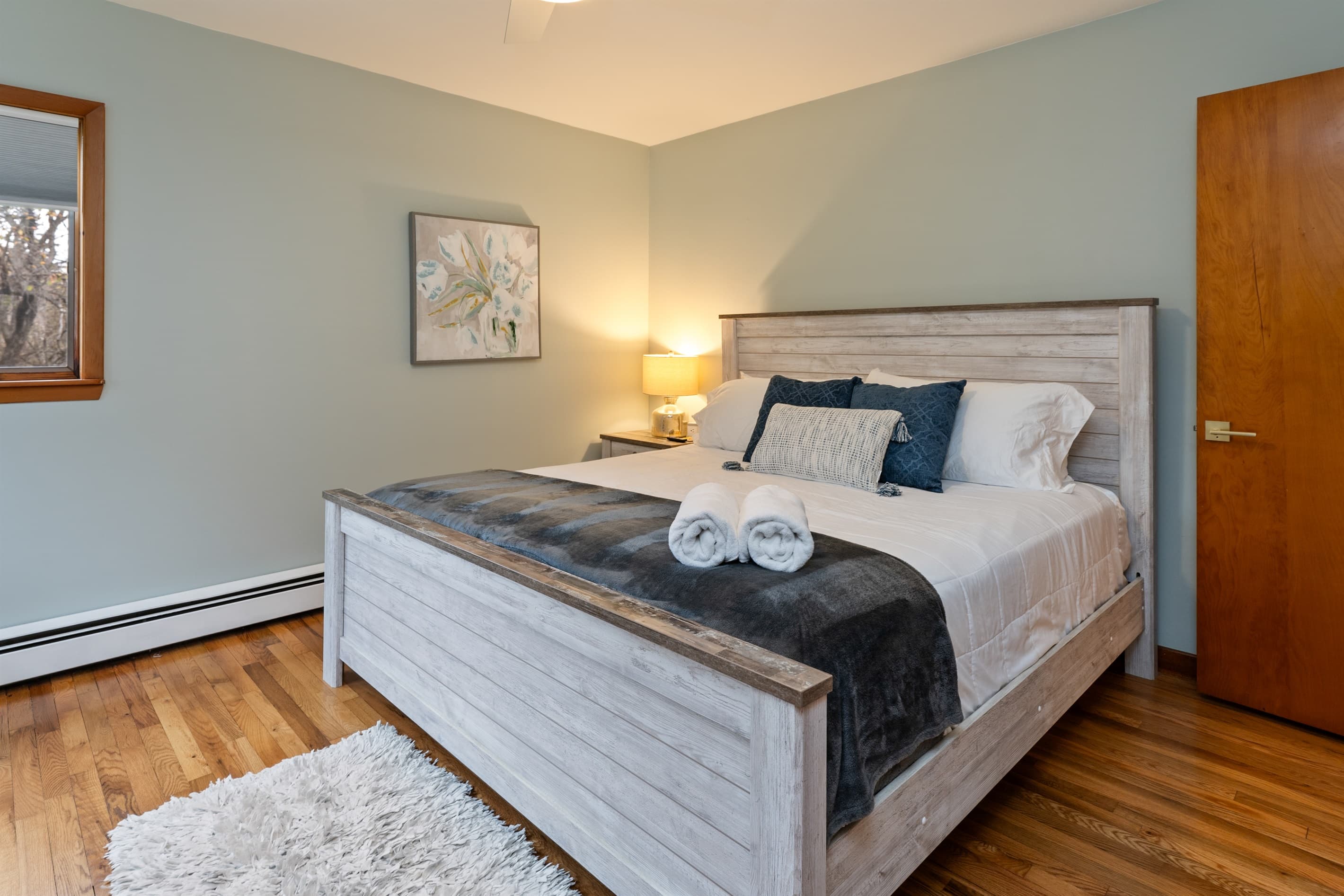 Main-floor king bedroom with wood furnishings
