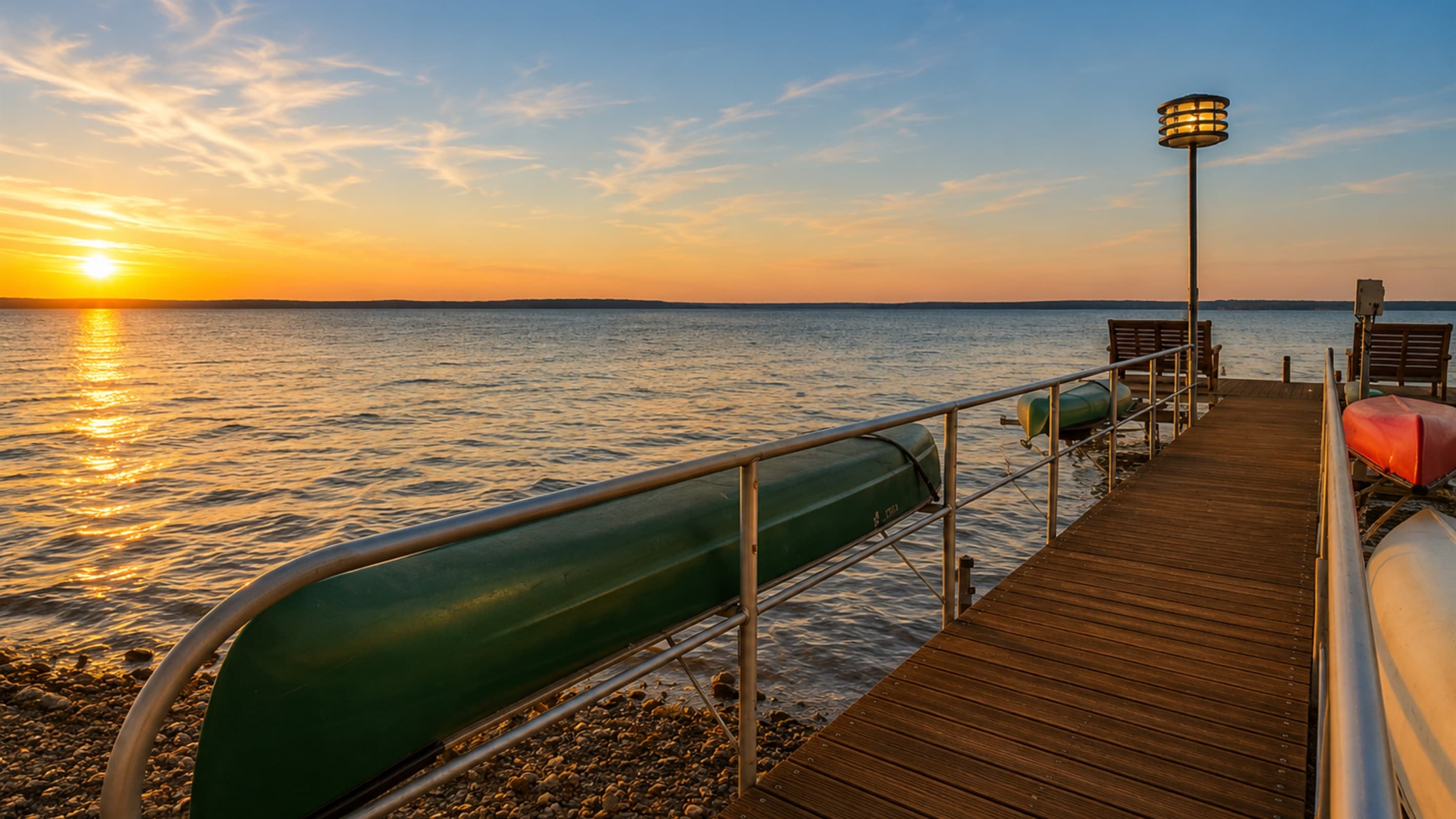 Private dock with canoe at sunset