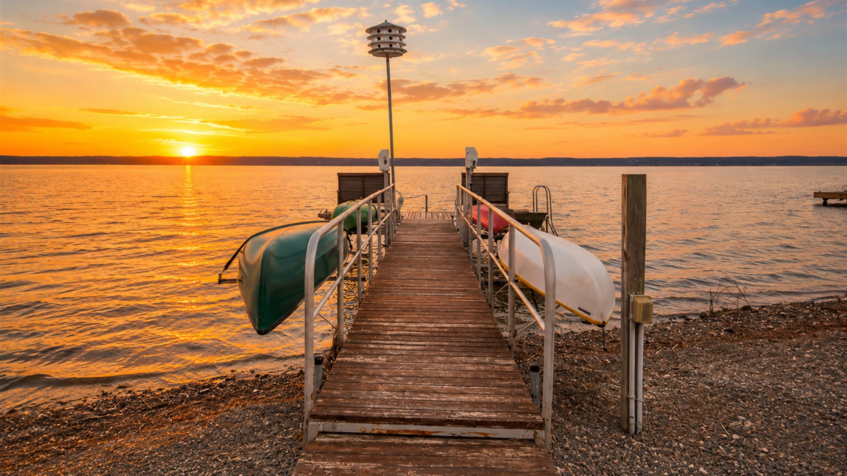 Private dock and canoe beneath golden skies