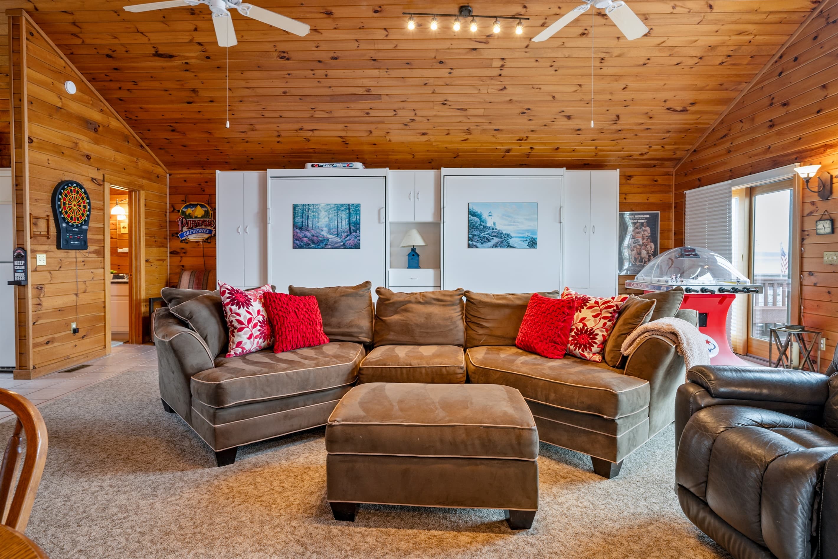 Wood-paneled living room with sectional seating