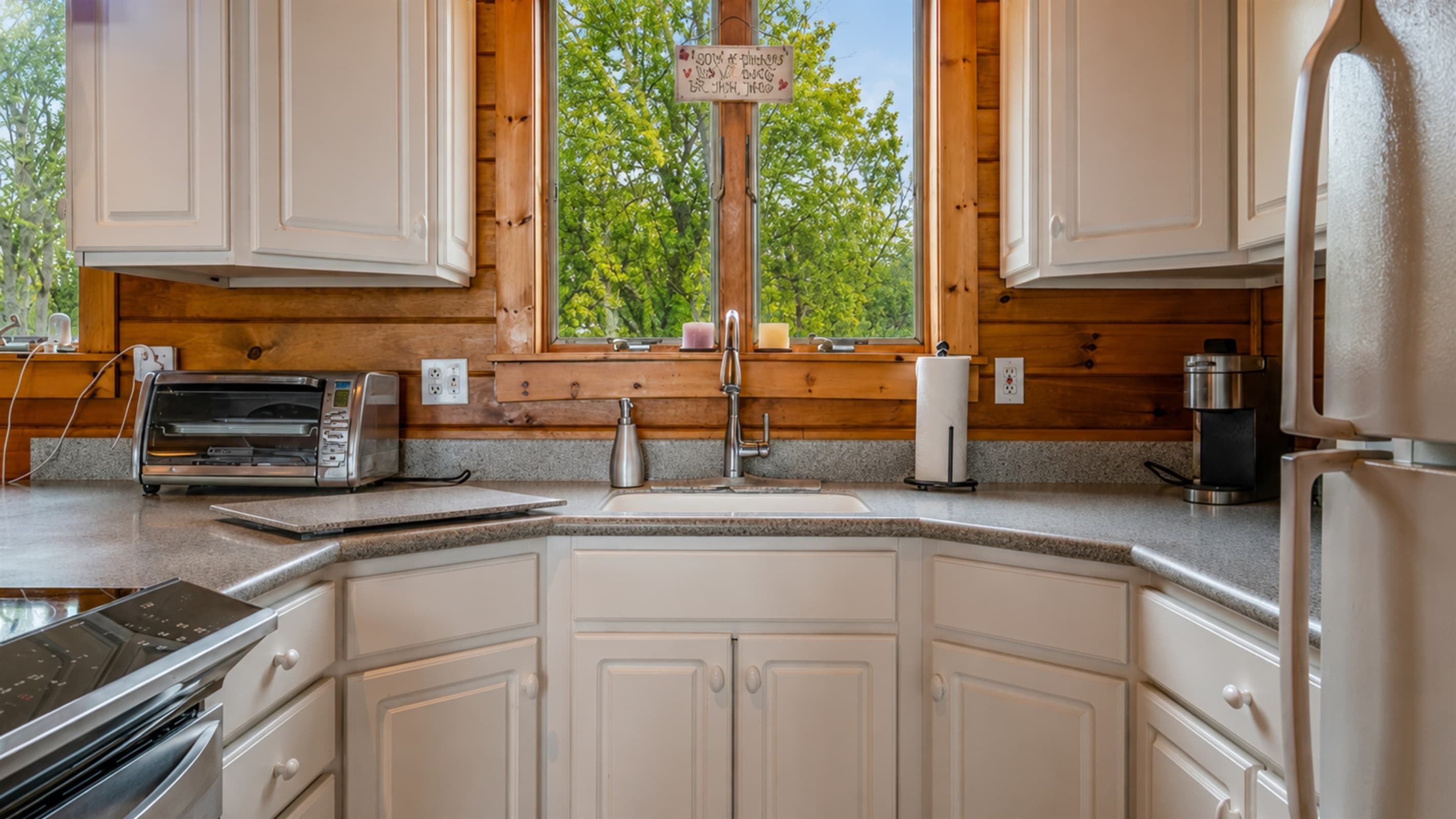 Kitchen with modern appliances and wooded views