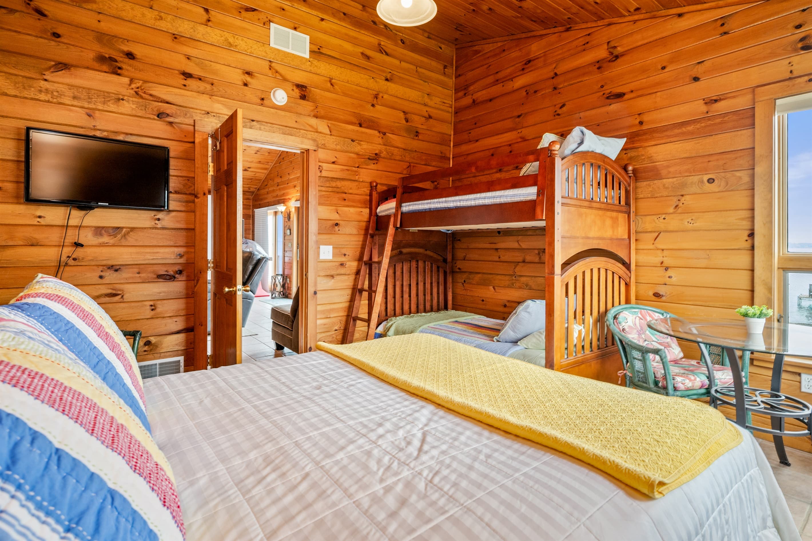 Wood-paneled bedroom with multiple beds