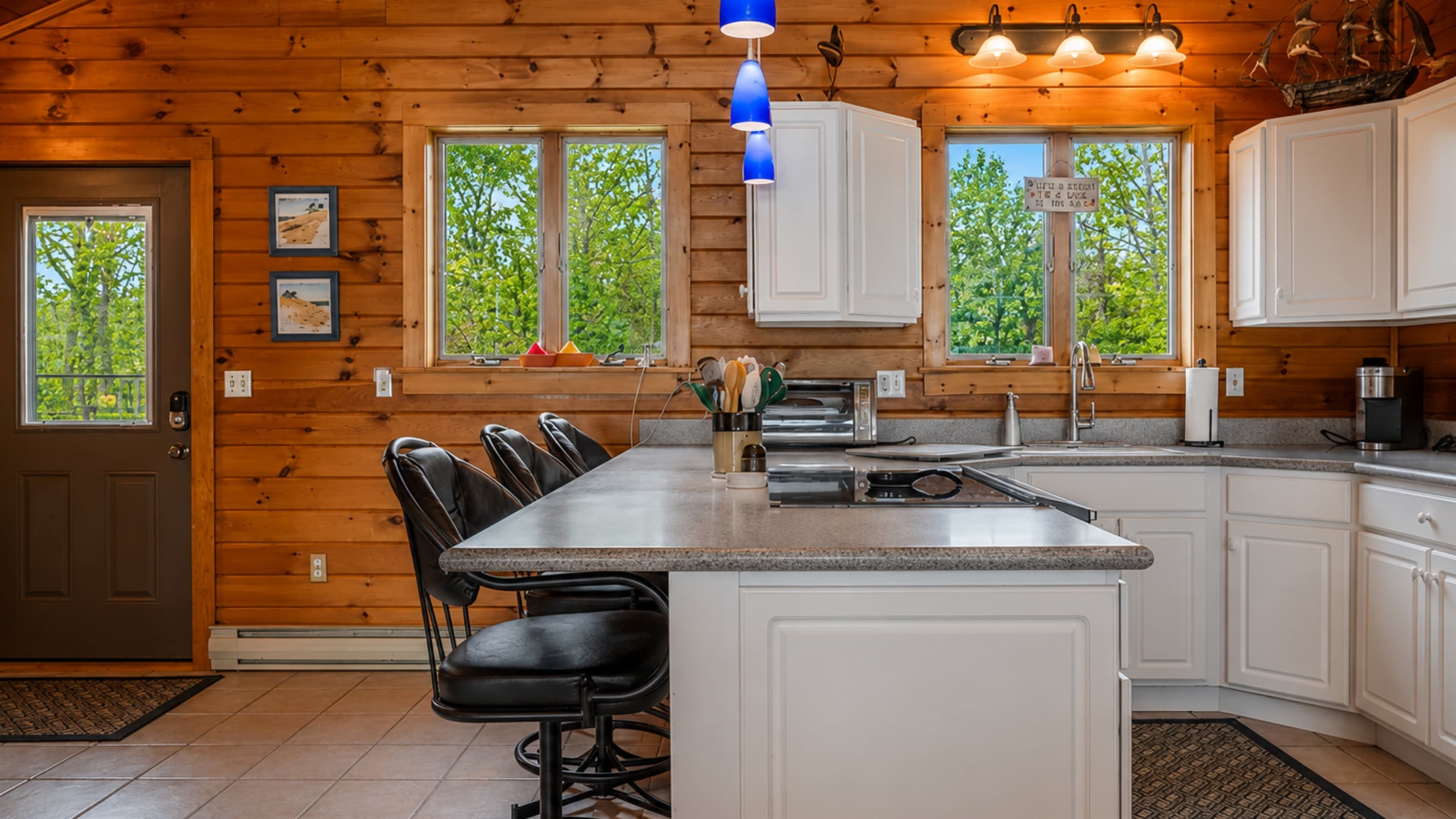 Open kitchen with wooded window views