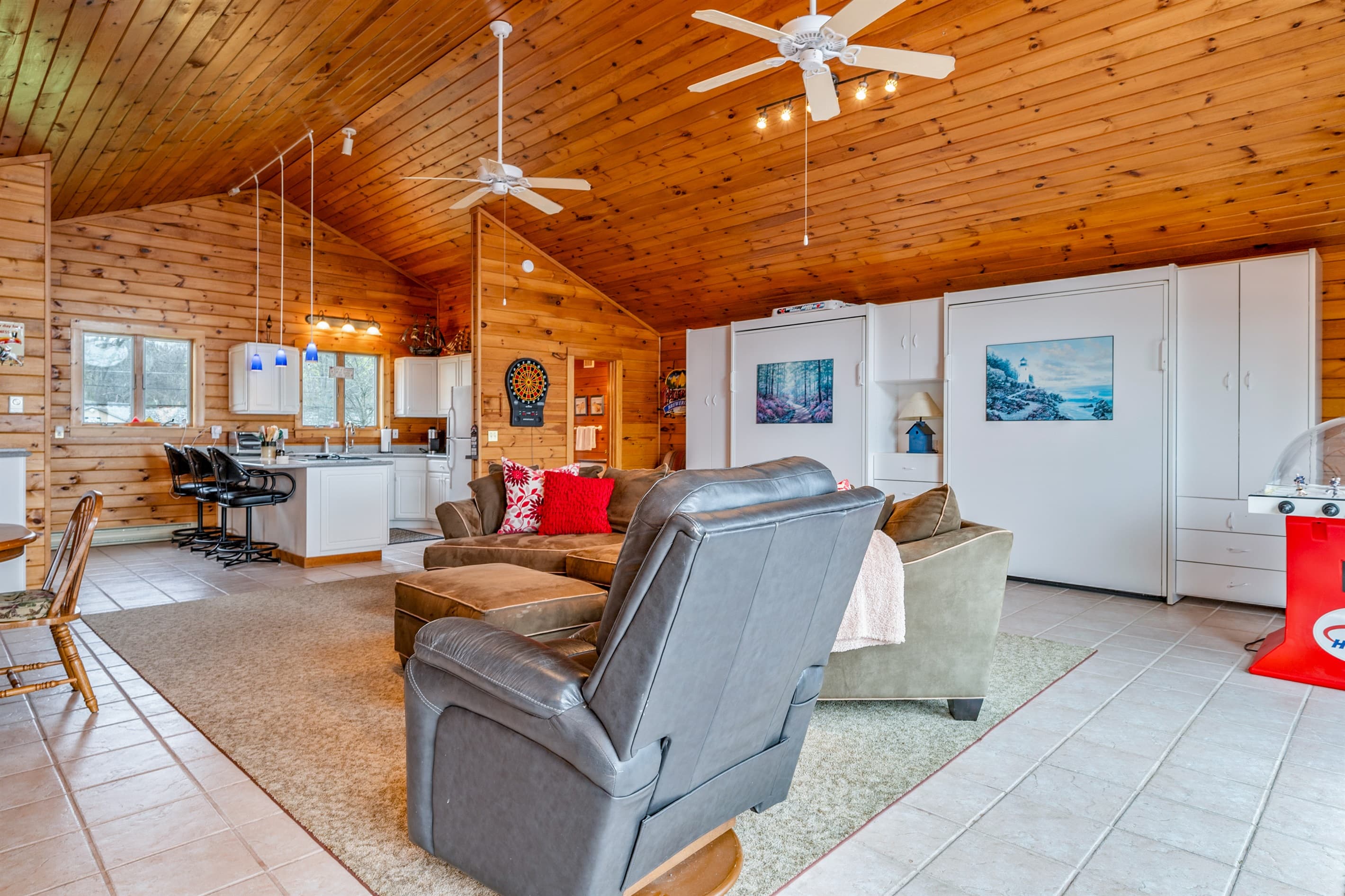 Wood-paneled living room with sectional seating