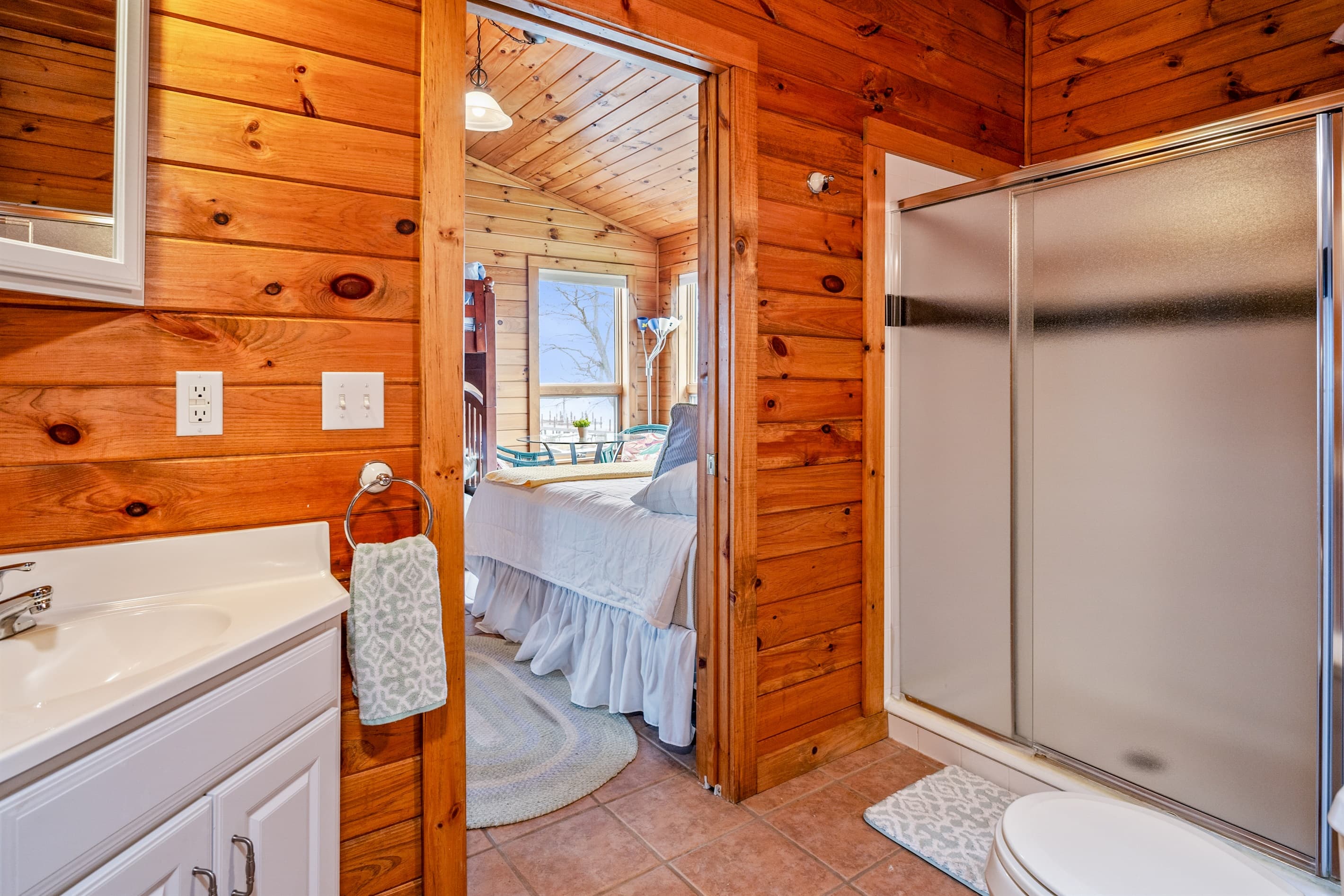 Wood-paneled bathroom with glass-enclosed shower