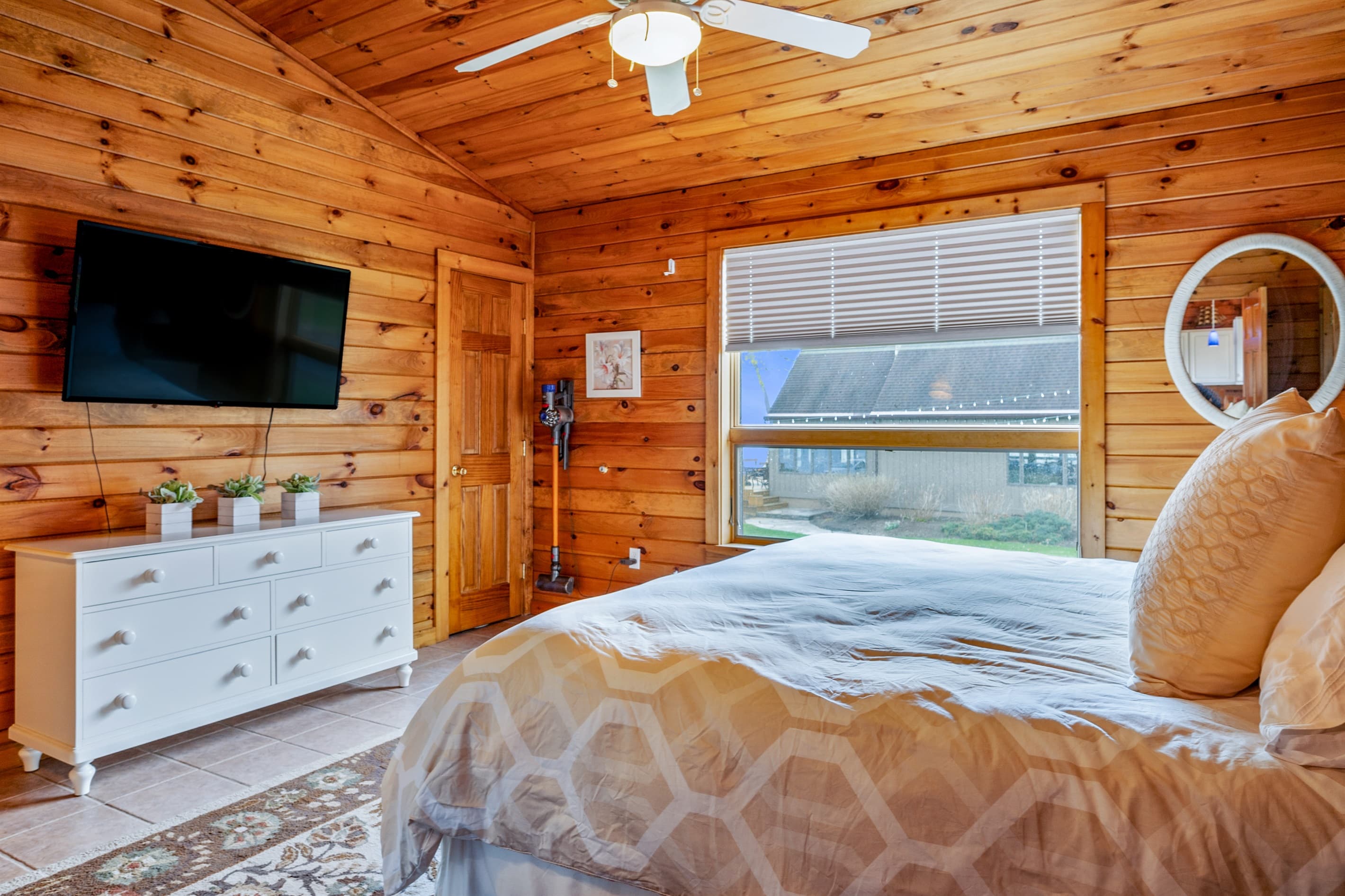 Bedroom with television and wood-paneled walls